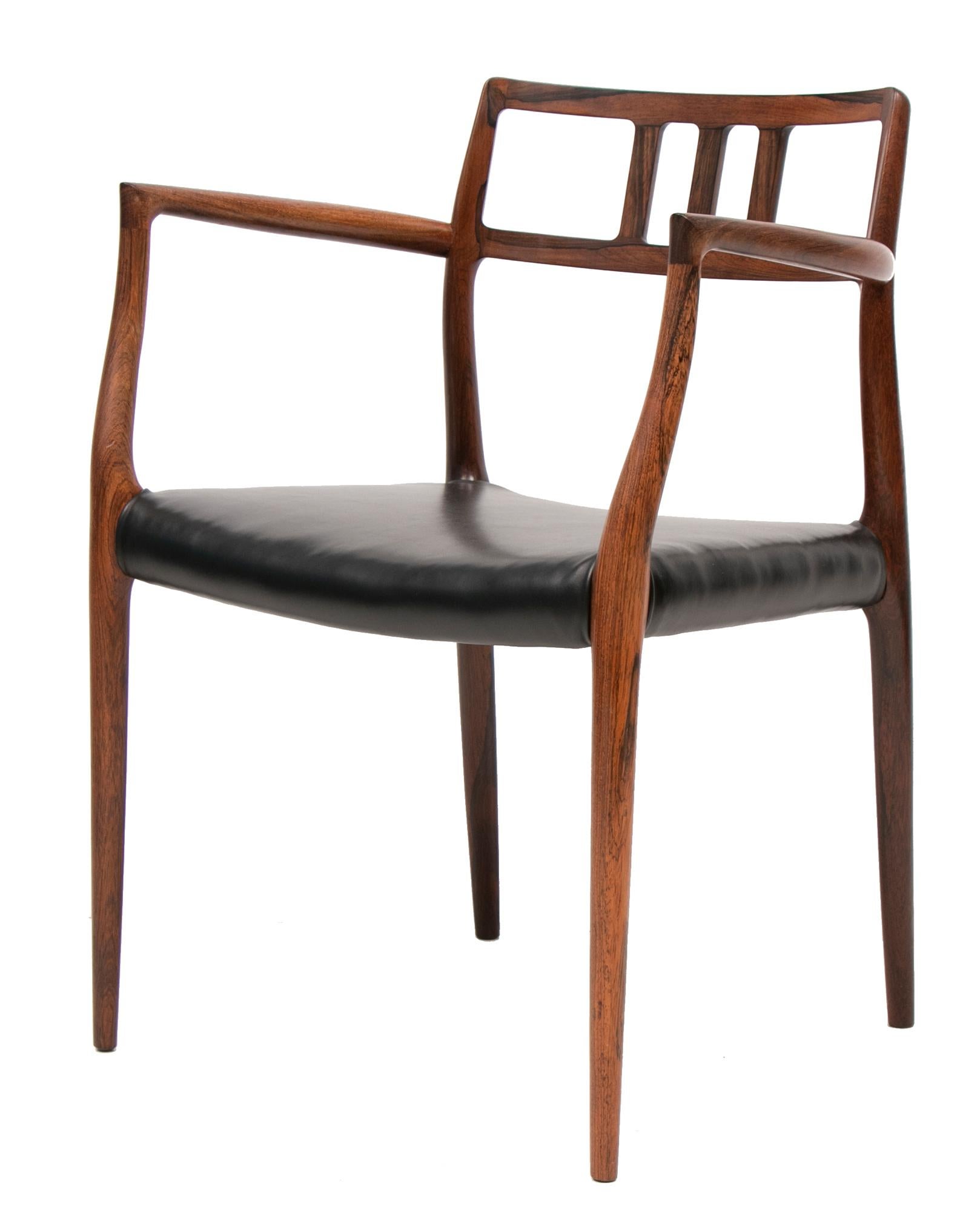 An absolutely gorgeous Danish midcentury rosewood and leather armchair Model 64 designed in 1966 by Niels O. Møller for his own workshop J.L Møller. The chair has been fully restored and reupholstered with premium quality black leather. Makers mark