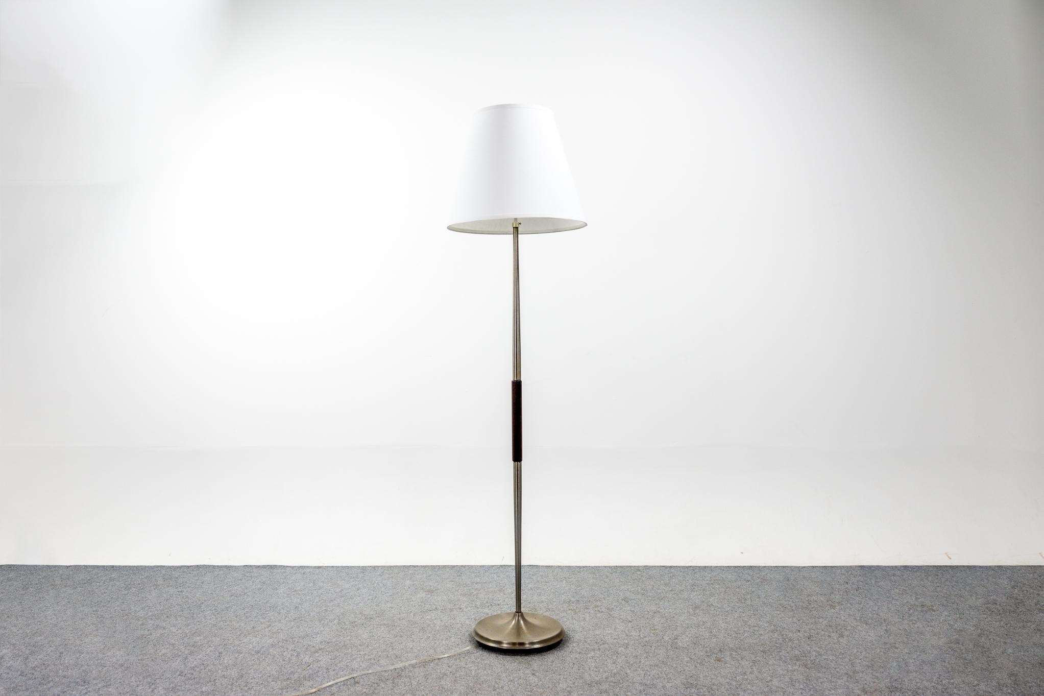 Rosewood and metal Danish floor lamp, circa 1960's. Custom quality shade, in keeping with the vintage aesthetic. Tri-light bulb and fixture give the user the option to adjust the brightness of the lamp to suit different lighting requirements.