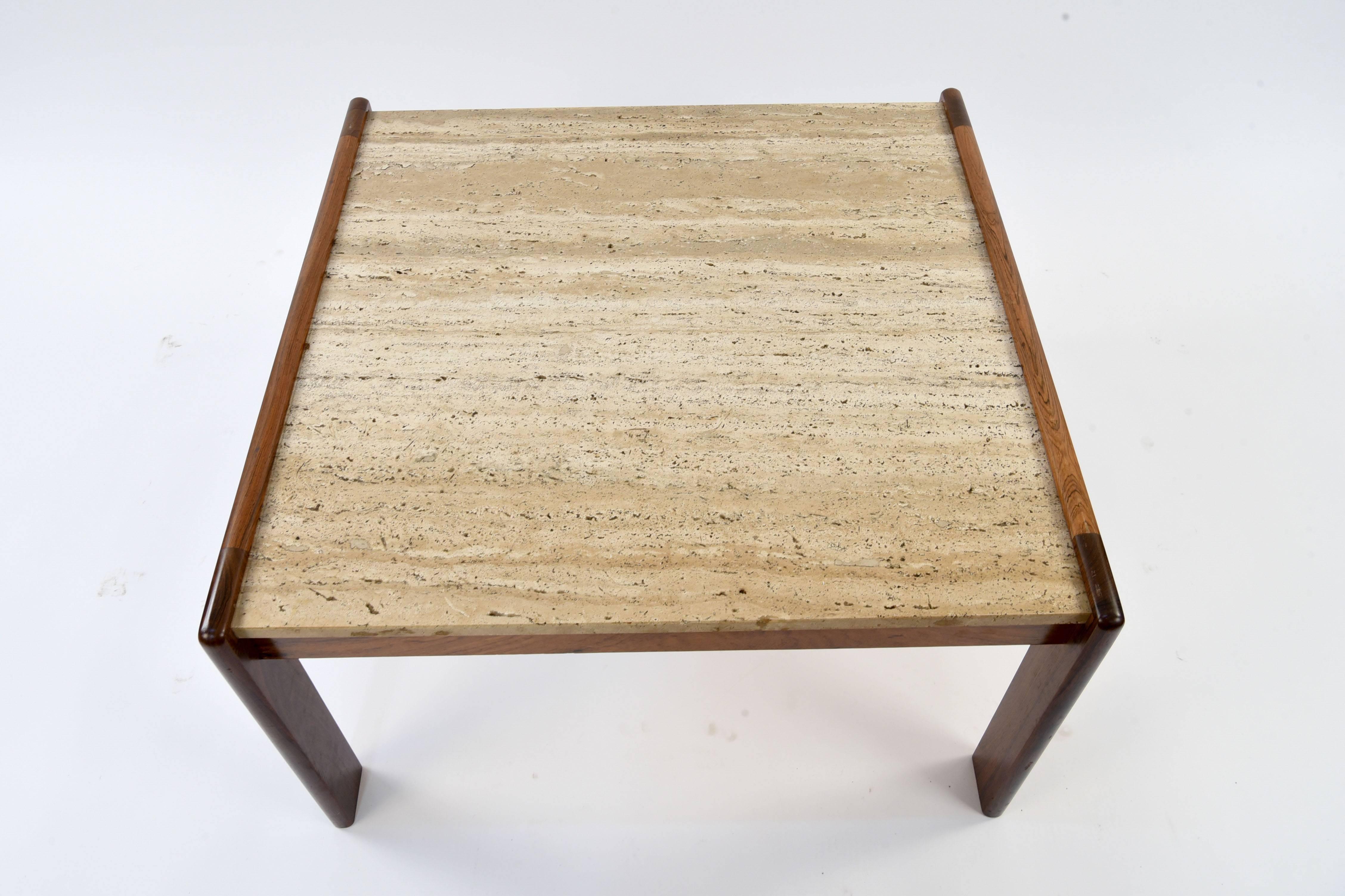 This Danish coffee table features stunning rosewood with a beautiful travertine top. Nice linear shape.