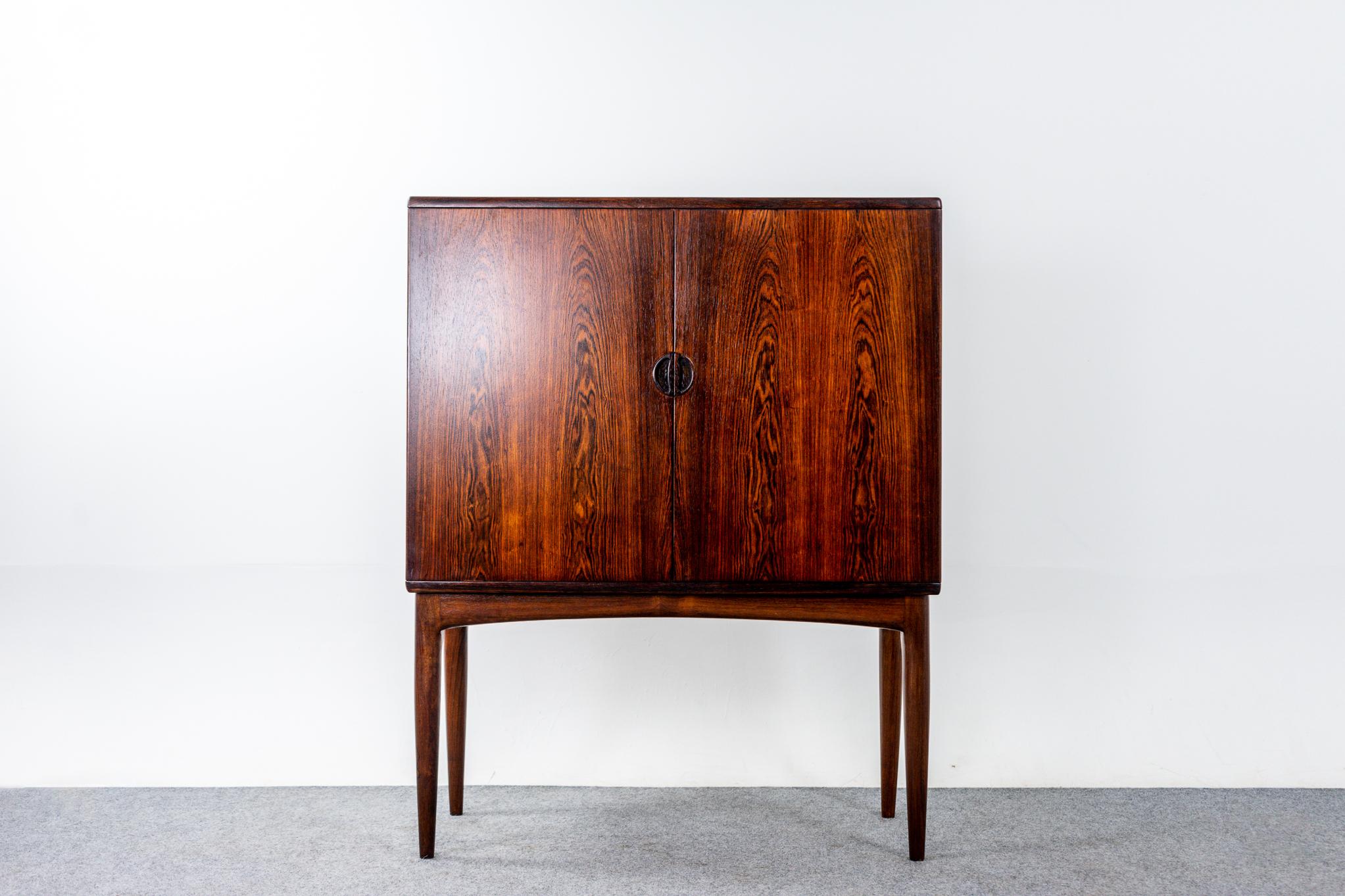Rosewood Danish cabinet/bar, circa 1960's. The ultimate drink serving station with exquisite grain patterning. Book matched double doors open to reveal fitted interior with mirror and interior light that triggers when opened. Two rows of glass