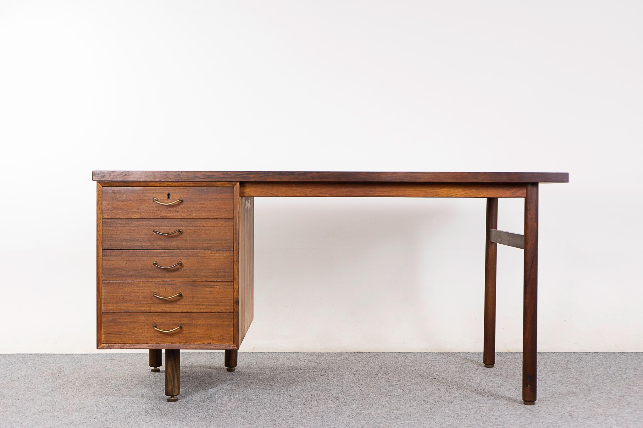 Rosewood Danish desk, circa 1960's. Unique 5 legged design with metal pulls and a bank of drawers that all lock at the same time from the top! Finished on both sides, if placed in the center of a room it will look fantastic from every angle. 