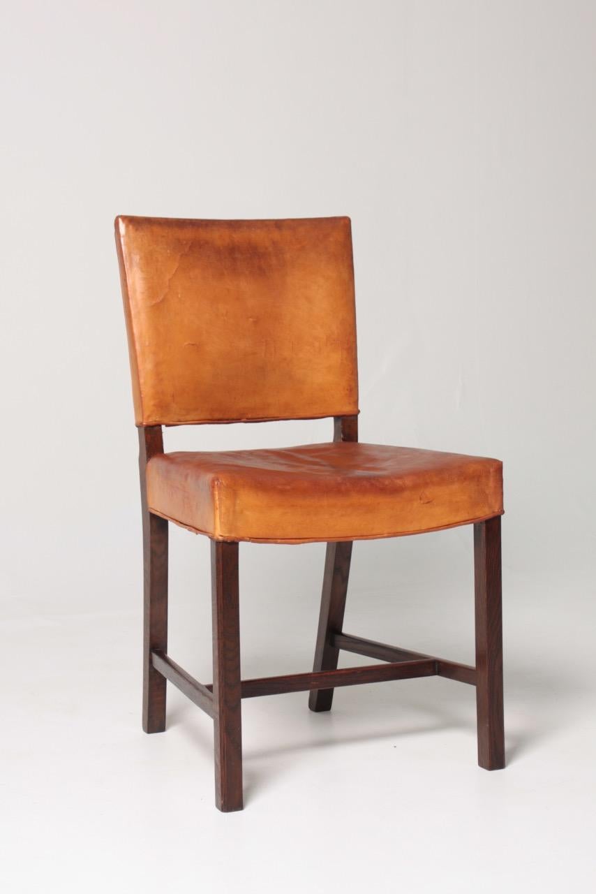 Side chair with in patinated leather and oak. Designed and made in Denmark, original condition.