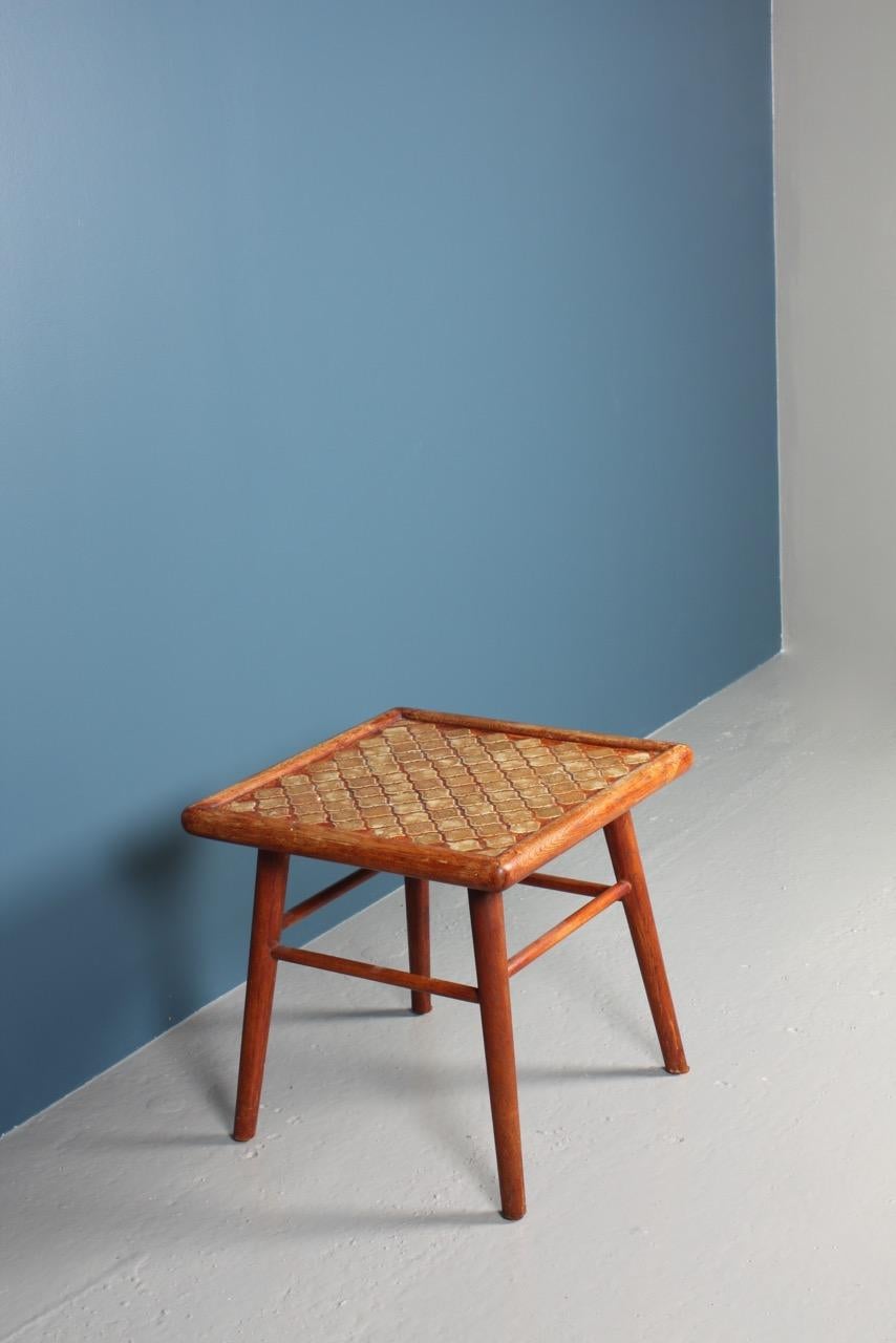 Side table with a solid oak base and porcelain top. Designed and made in Denmark. Original condition.