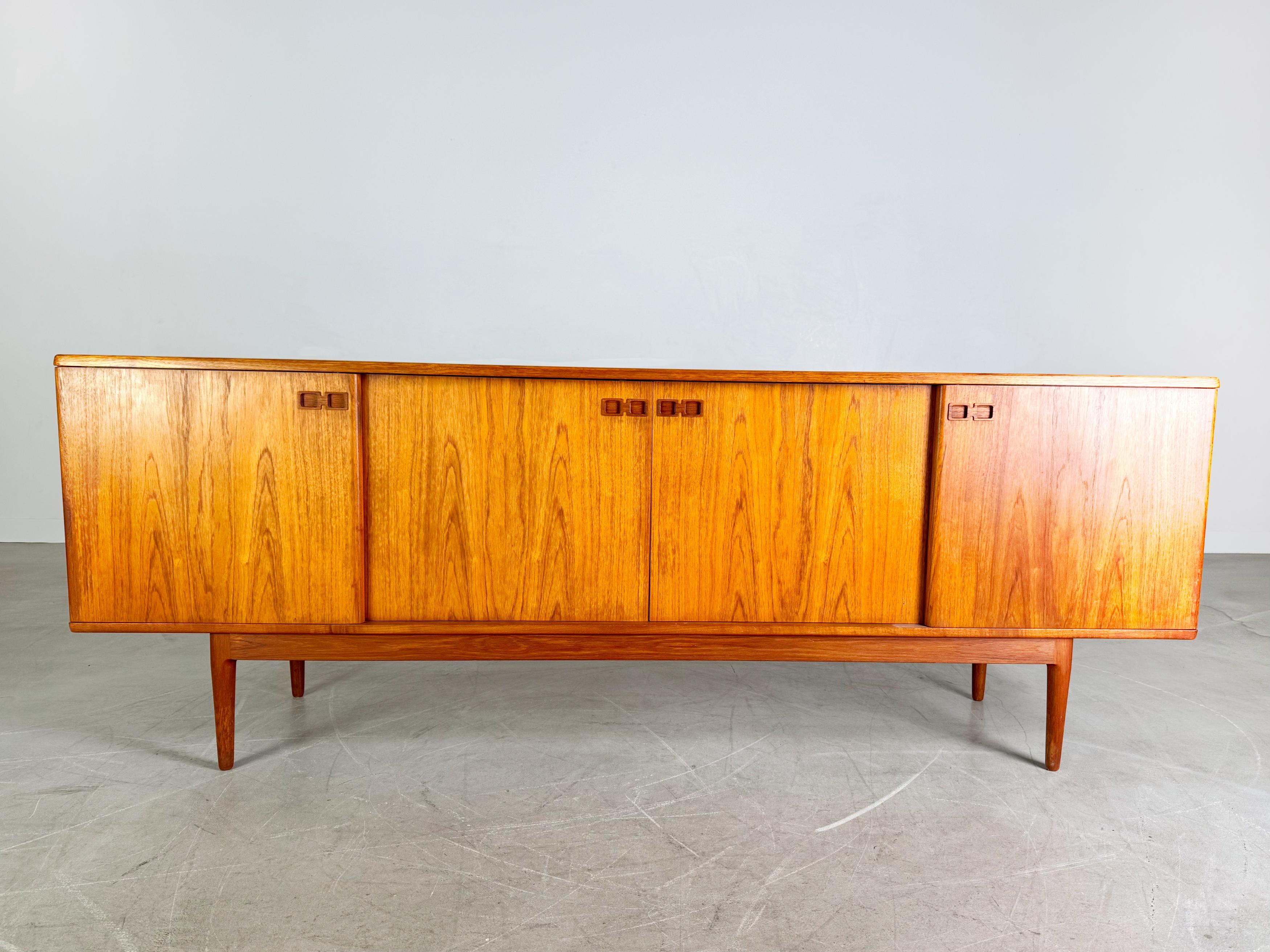 We are offering a very beautiful and rare mid-century teak sideboard by Christian Linneberg for sale. The sideboard has four sliding doors and a total of four small drawers on the inside.

Condition: Good to very good used condition with age-related