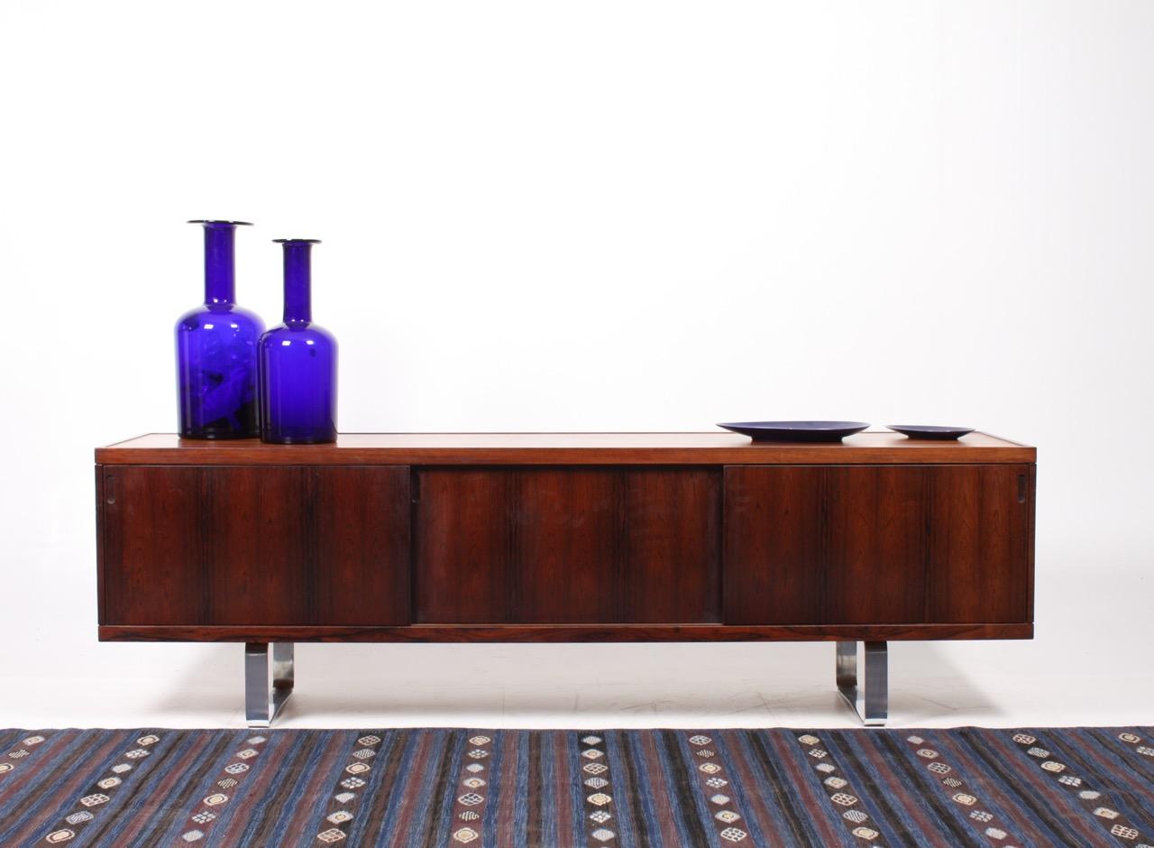 Great looking sideboard, front with three sliding doors and legs of chromed steel. All interior is in solid oak. Designed by Jørgen Pedersen for E. Pedersen & søn. Great original condition.
