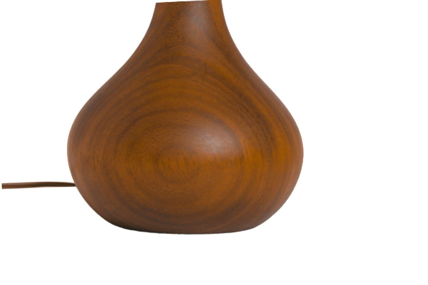 This is an absolutely beautiful mid century teak table lamp of superior craftsmanship, circa 1960s, made in Denmark. Features sculptural bulbous form sleek profile, composed of a rich teak grain, with a rich wood finish. The lamp is fitted with an