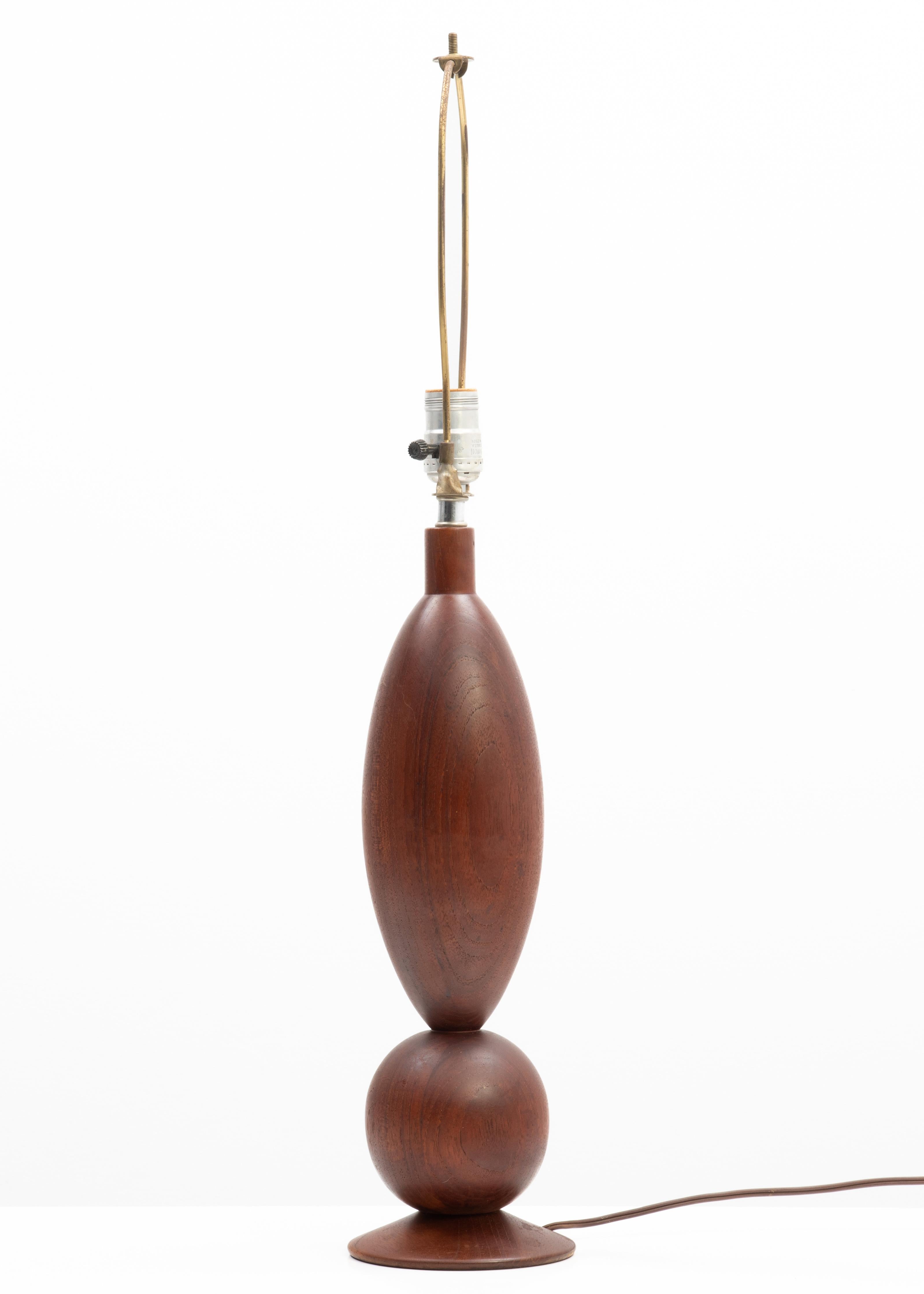 A sculptural solid teak table lamp in the manner of ESA. Made in Denmark or Sweden, 1970s. The wood section is 17.25” tall.