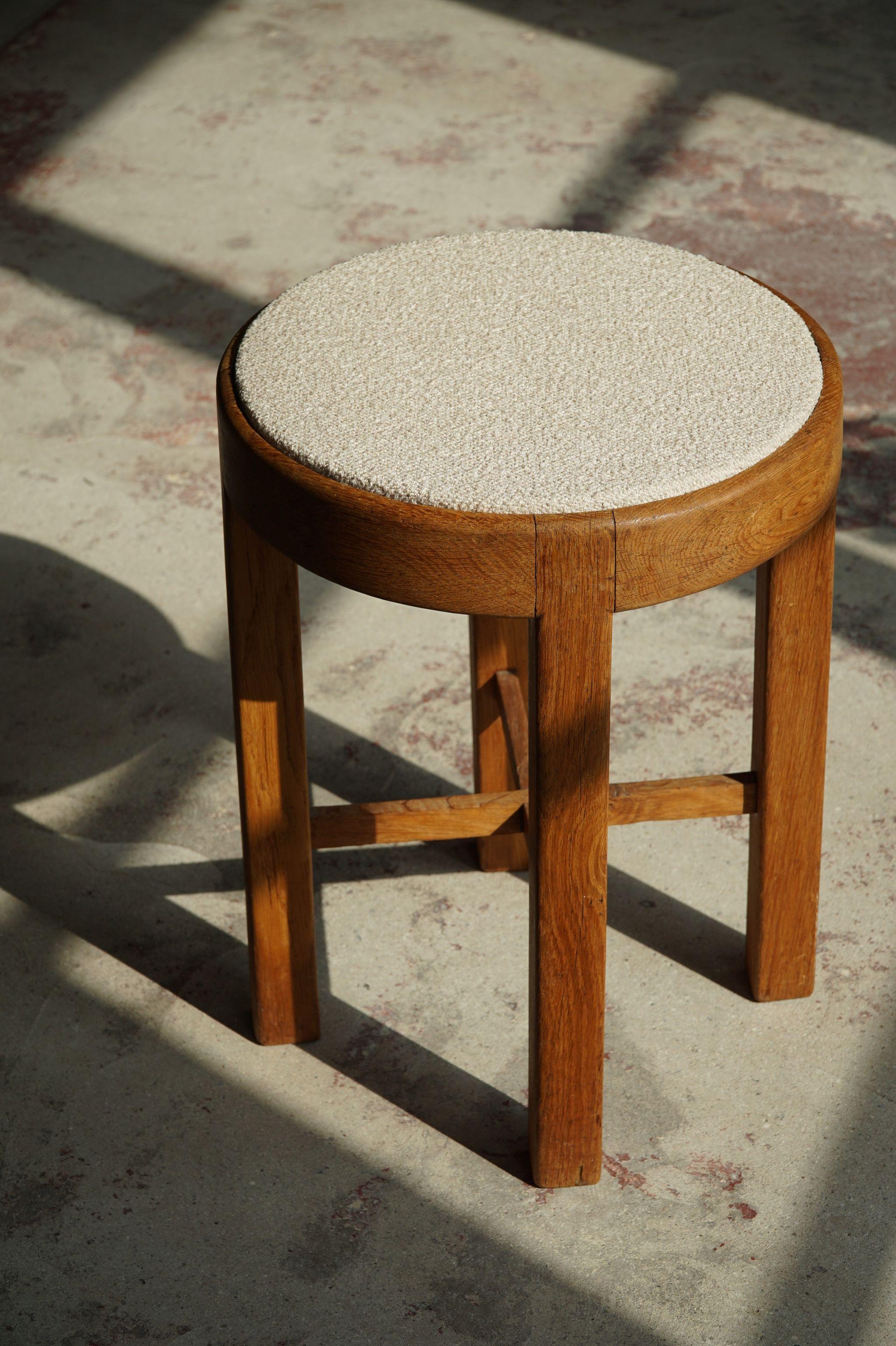 Sculptural stool in oak and reupholstered in bouclé. Made in Denmark, ca 1950s.

A bit of a masterpiece. Great craftmanship that reminds us of the work from Rud Rasmussen.