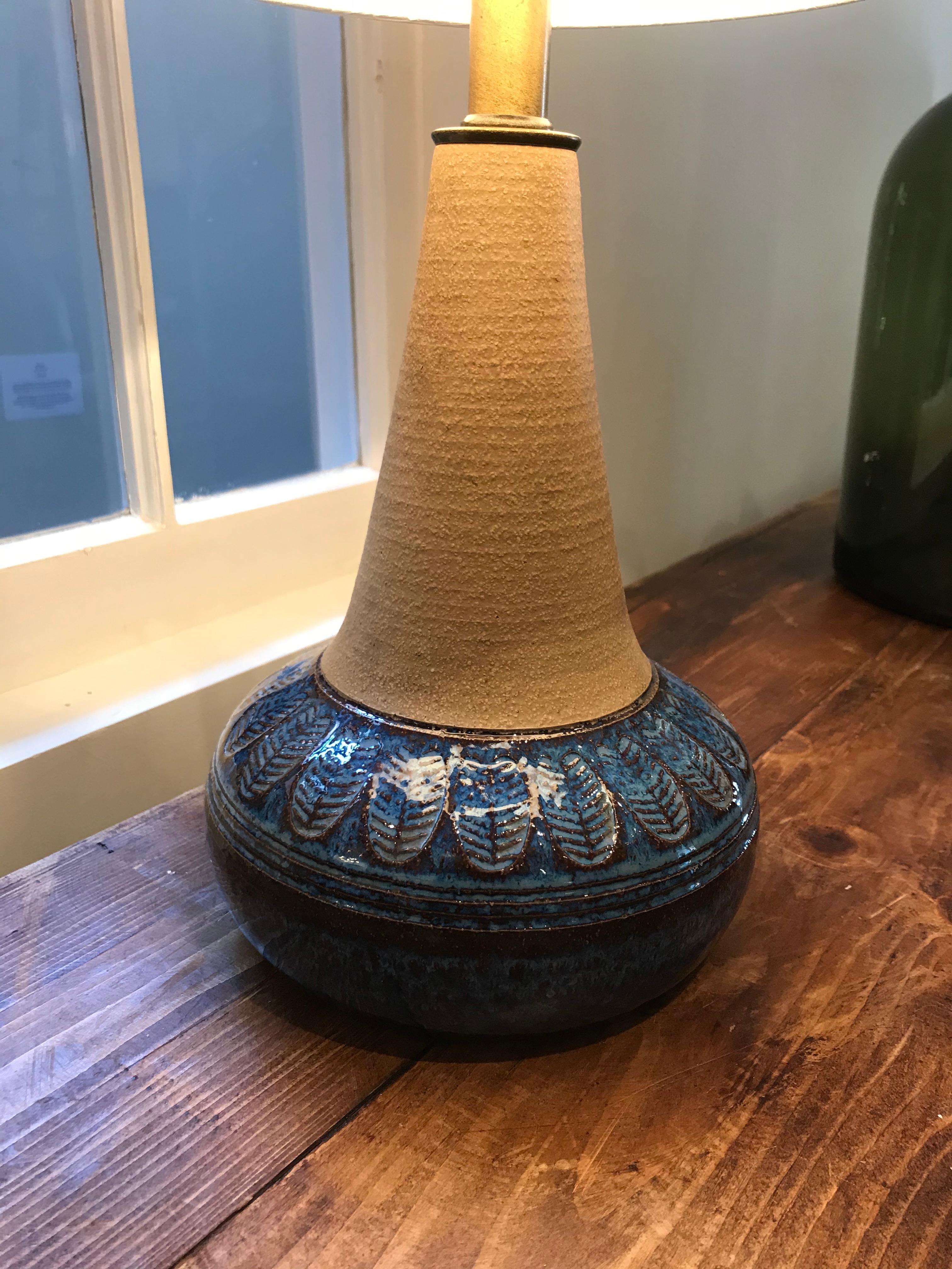 Handmade table lamp with a beautiful blue glaze for its base.
Makers mark on the bottom of base.