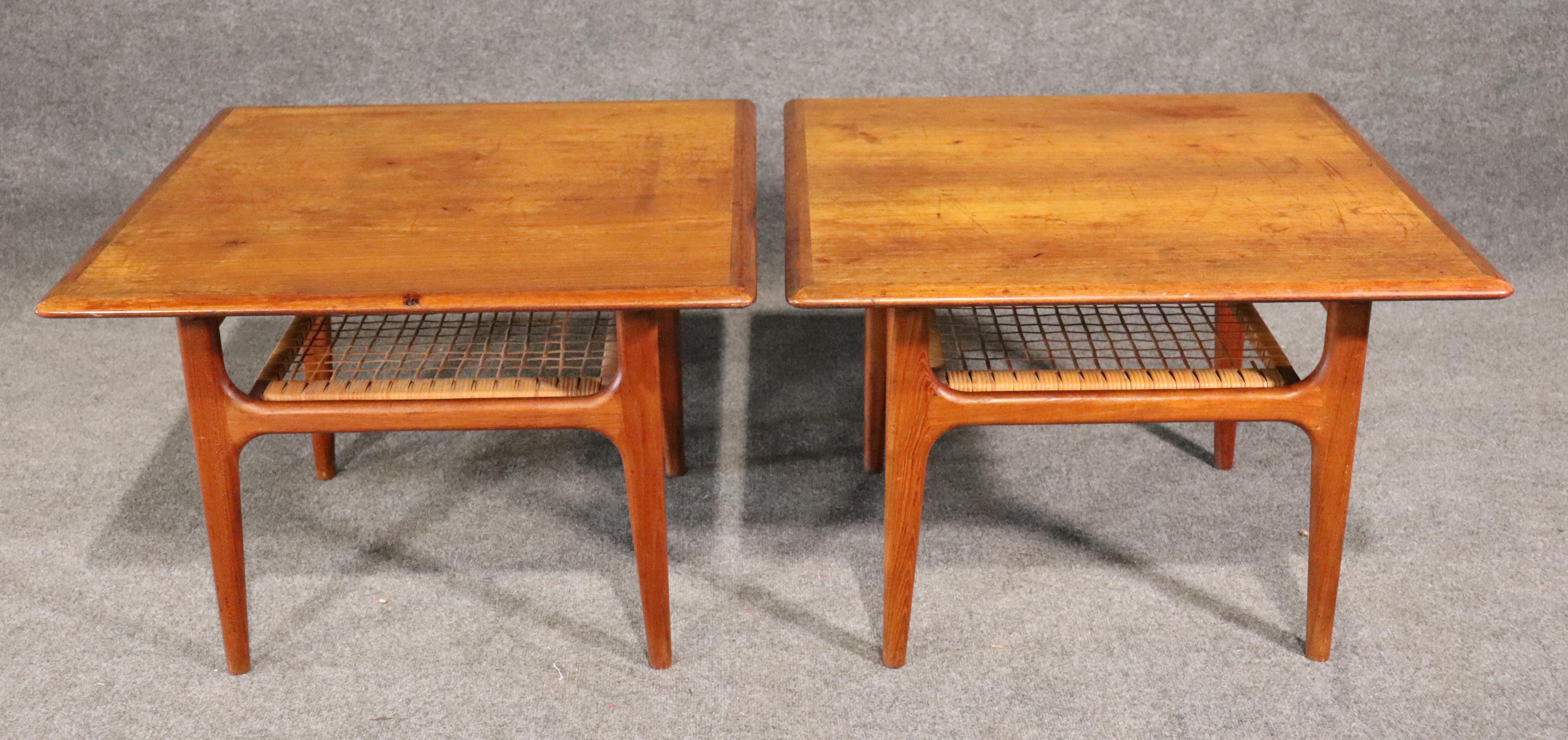 Danish maker Trioh designed tables with warm teak grain and woven shelf. Tapered legs and makers stamp underneath.
Please confirm location.