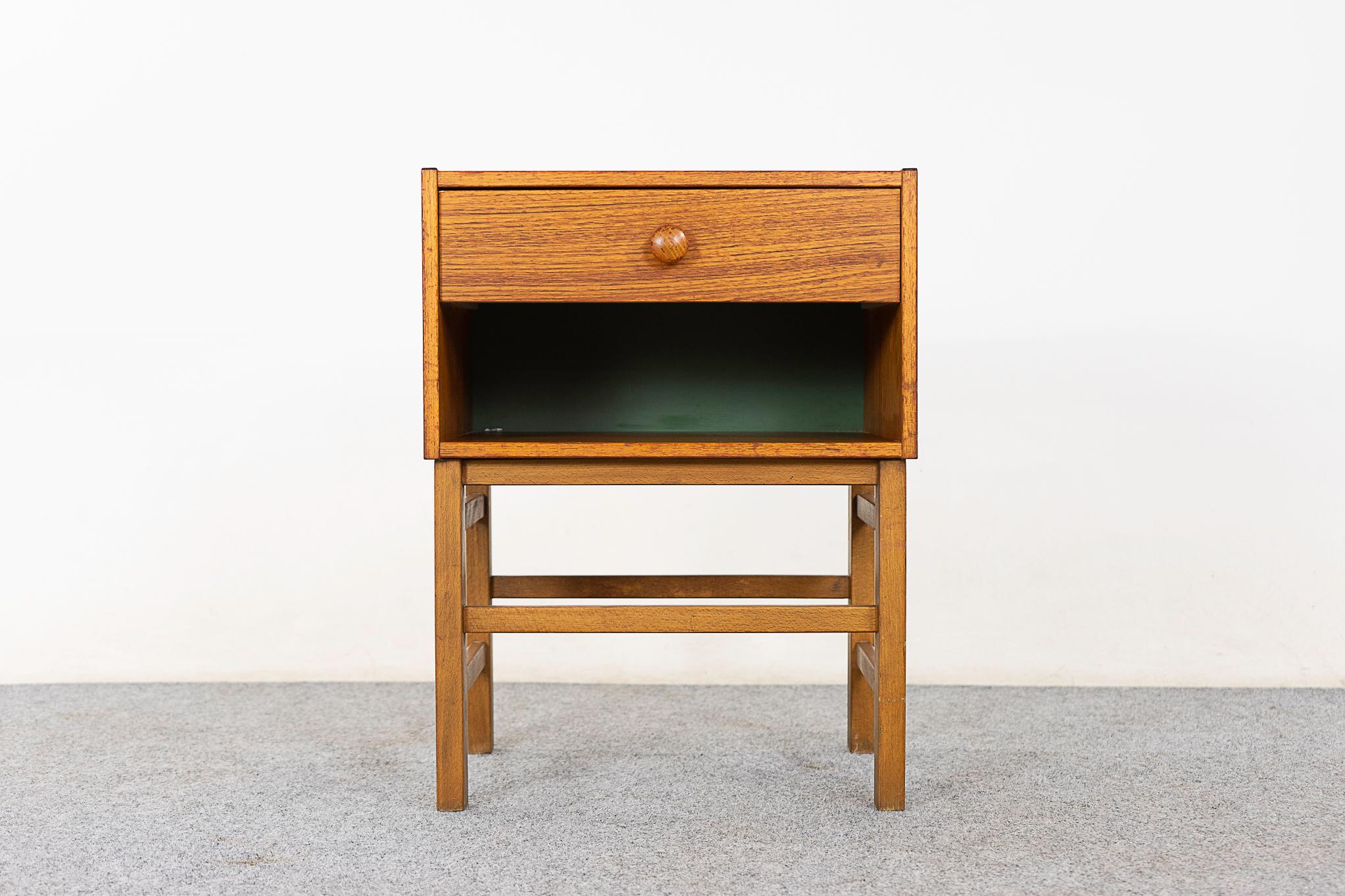 Teak & beech Danish bedside table, circa 1960's. Compact single drawer table with open cubby. Veneered case rests on a robust base with cross supports. 

Please inquire for remote and international shipping rates.