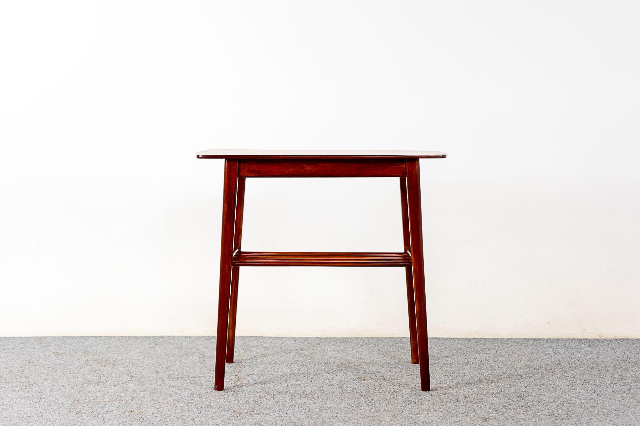 Teak & beech side table, circa 1960's. Solid beech wood construction on base, and handsome book-matched teak veneer top! Handy shelf for the space conscious homeowner!

Please inquire for remote and international shipping rates.