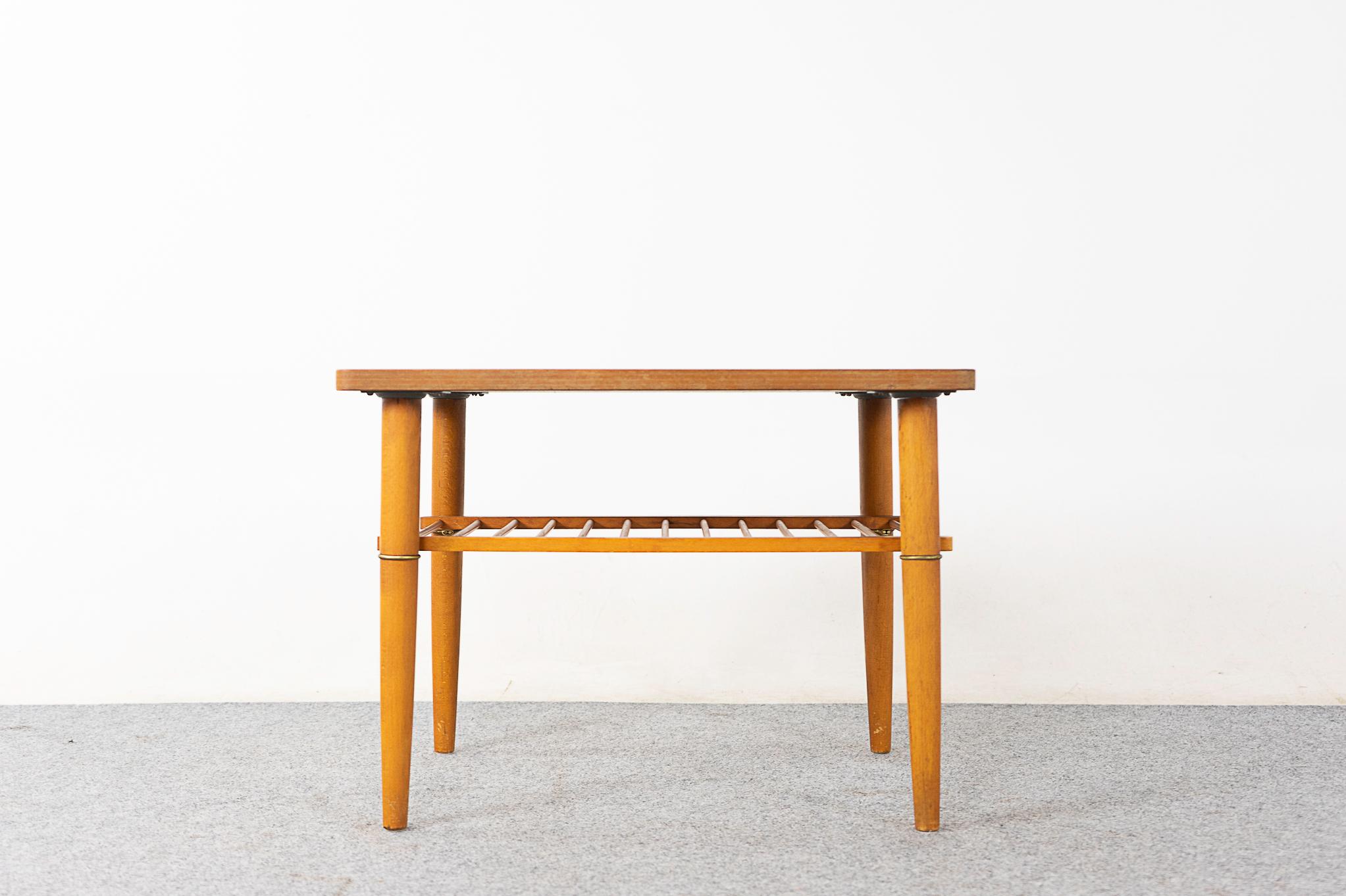 Teak & beech mid-century side table, circa 1960's. Compact size with lovely metal ring accents and slatted shelf. Handsome book-matched veneer teak on top and solid beechwood legs.
