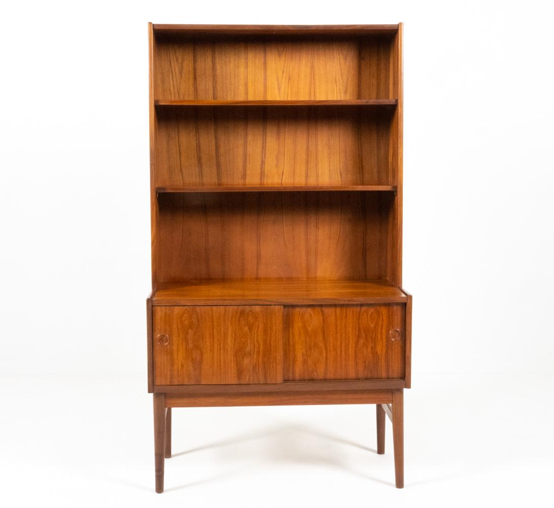 The tapered bookcase-secretary is an icon of Mid-Century Modern design. Despite its compact proportions, this unique form delivers ample storage, multifunctional utility, and a bold, Atomic-inspired silhouette - making it a beloved fixture in