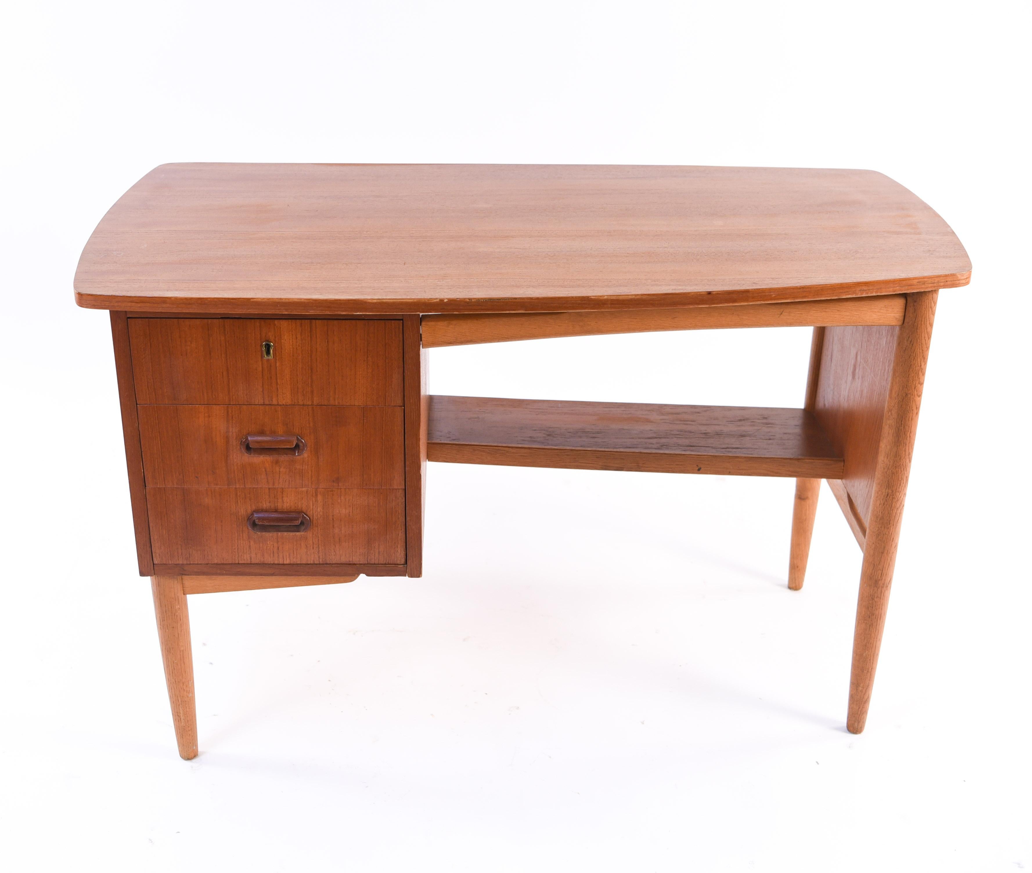 Work in style with this Danish midcentury teak desk. The juxtaposition of curved and straight edges gives this piece a unique, modern feel. Its petite size would be ideal for apartment living or smaller office space.