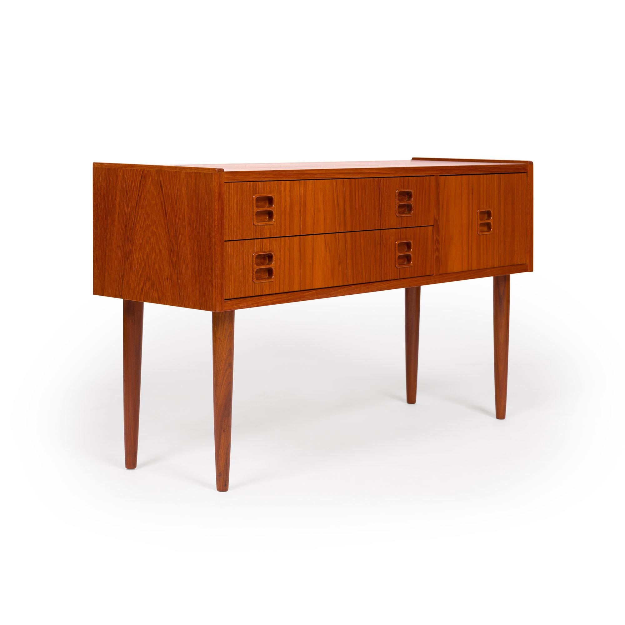 This unique vintage Danish mid-century teak chest, recently imported from Denmark, exudes timeless elegance and versatility. Its compact size and clean lines make it a perfect fit for various uses, whether as an entryway chest, nightstand, or end