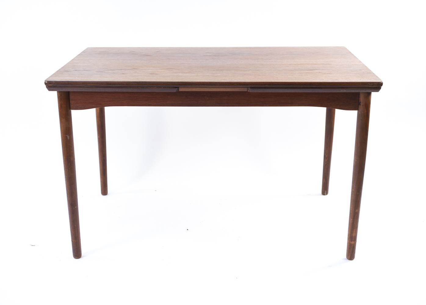 This Danish midcentury teak dining table features two pullout / pull-out leaves to accommodate additional people. A simple, timeless design whose versatility allows it to be used in any dining room.