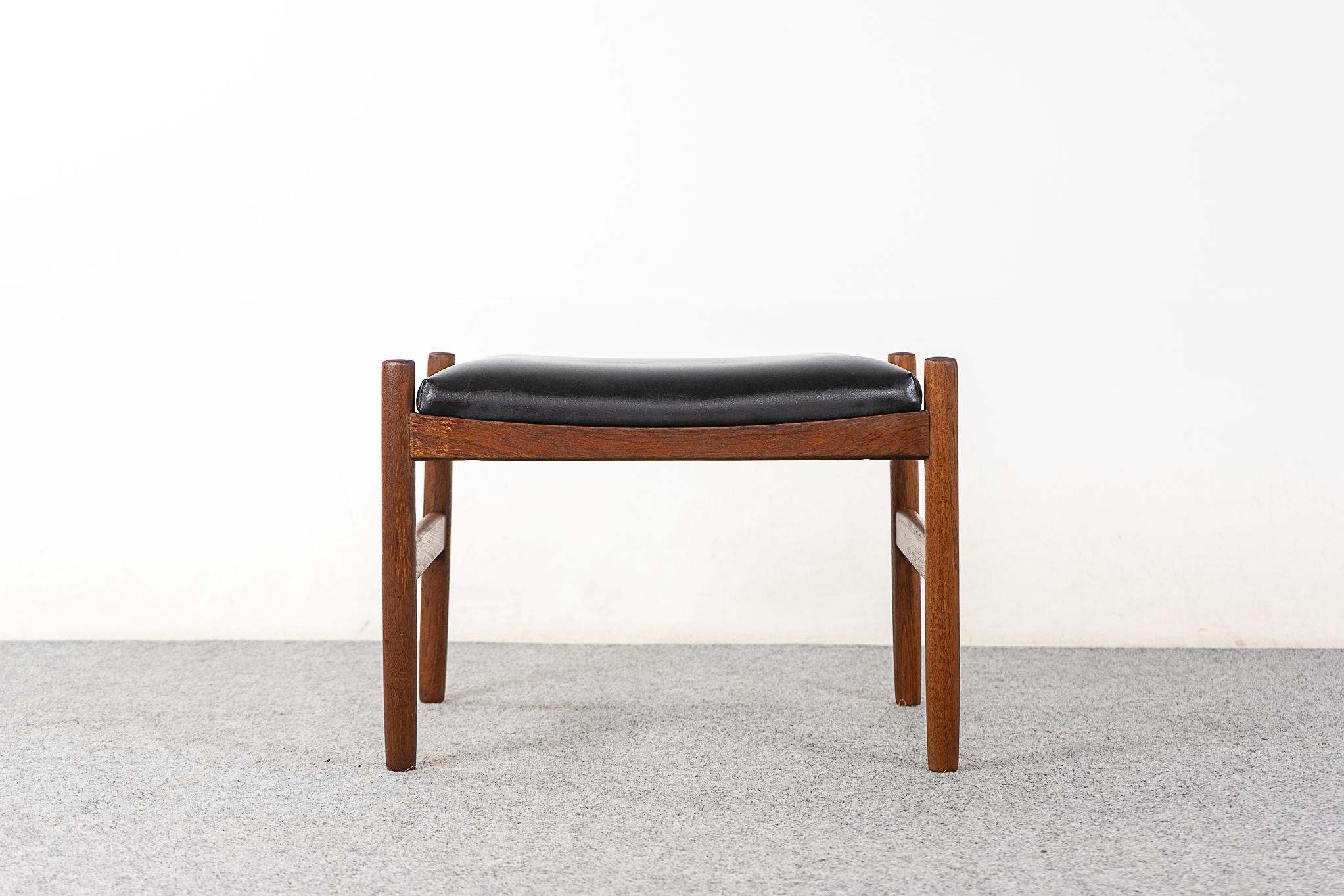 Teak Danish footstool by Spottrup, circa 1960's. Robust construction with cross supports and original upholstery. Spottrup & Danish Furniture Makers' control stamp intact.