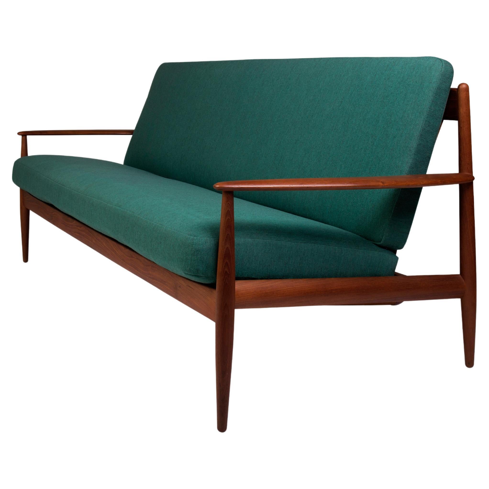Danish mid-century teak framed sofa with original spring coil cushions For Sale
