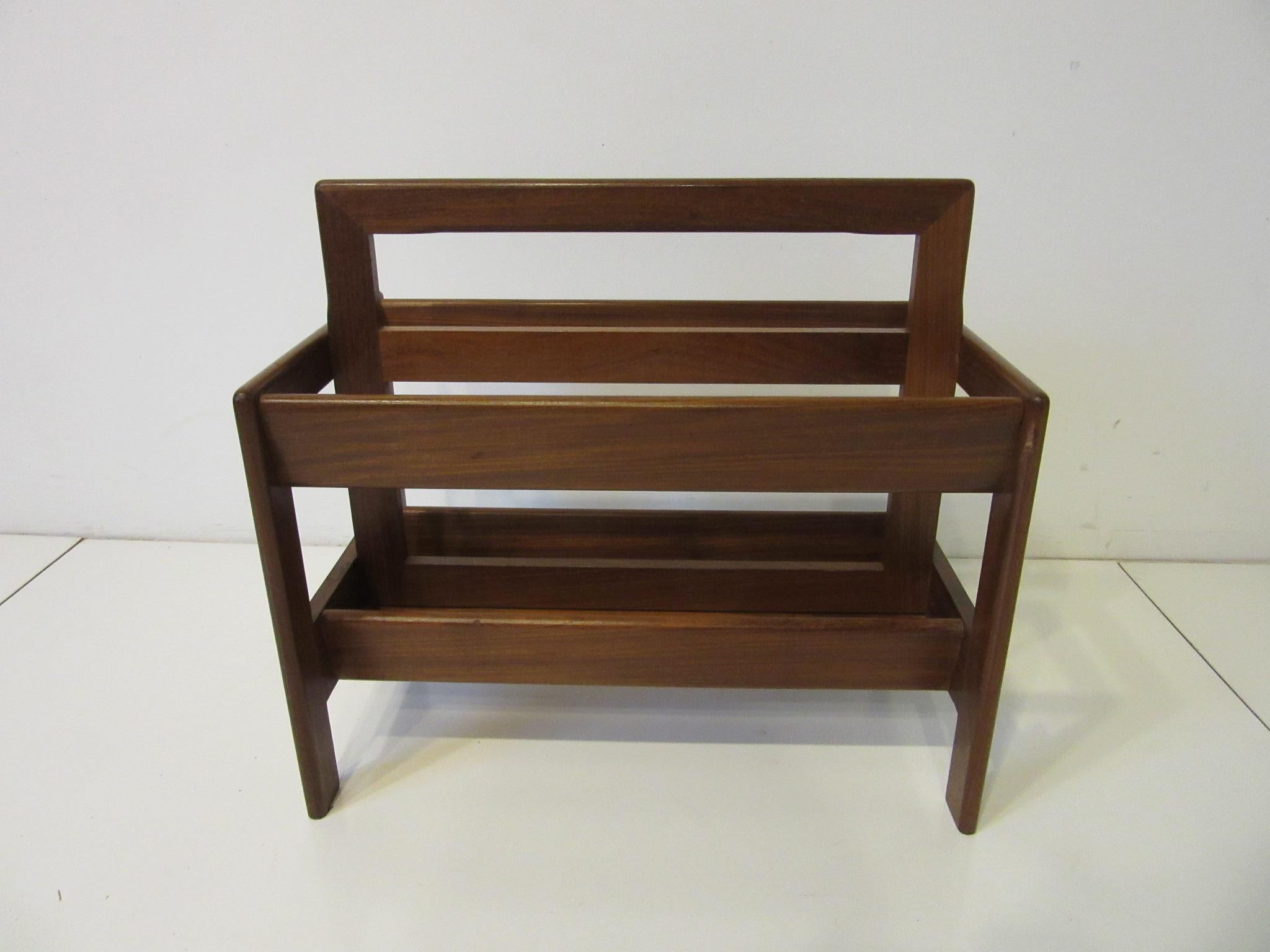 A very well crafted solid teak wood midcentury magazine rack with rounded edges built in handle and two large slots for your reading materials. Manufactured in Denmark.