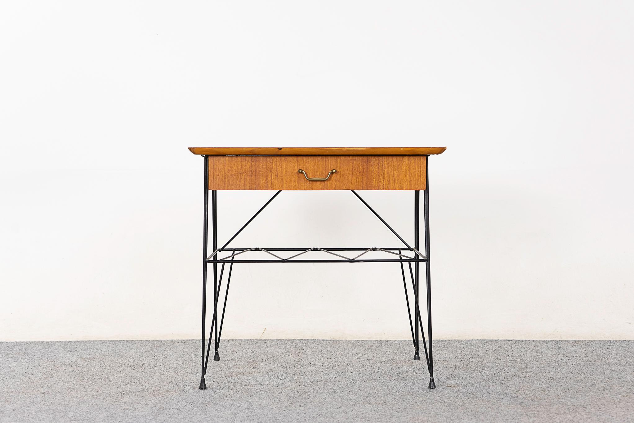 Teak & metal Danish bedside table, circa 1960's. Veneered case on slender hairpin base. Sleek drawer and airy shelf, a practical little piece!

Please inquire for remote and international shipping rates.