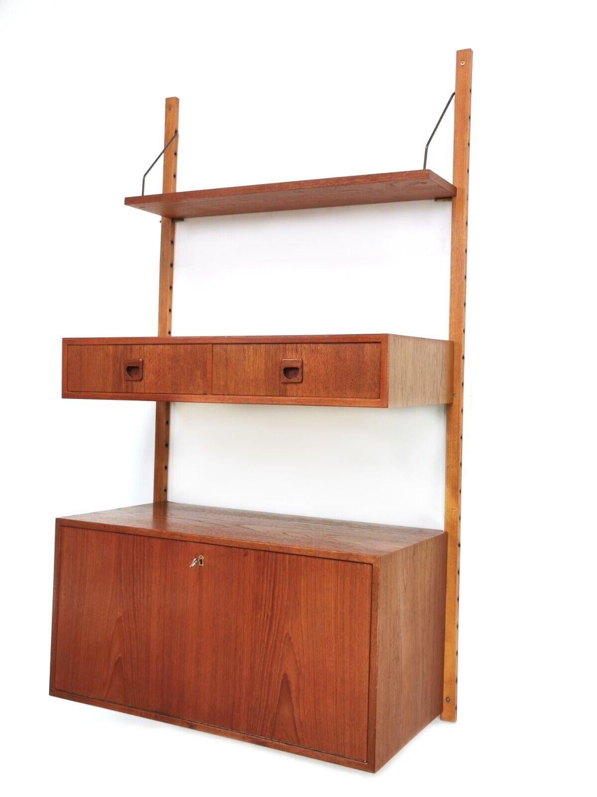 Danish teak modular Mid Century wall unit

Adjustable single bay mid century teak wall unit.

Arrange as you wish, but as it stands in the picture, the lower section consists of a fall front lockable mirrored cabinet. The middle section has two
