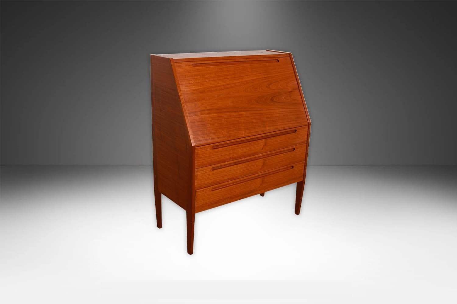 An elegant rare Mid-Century Modern teak secretary desk or vanity with mirror by famous Danish designer Kai Kristiansen for Torring, in Denmark. Featuring beautifully grained teak wood case and frame. The upper drop-down cabinet opens to reveal a