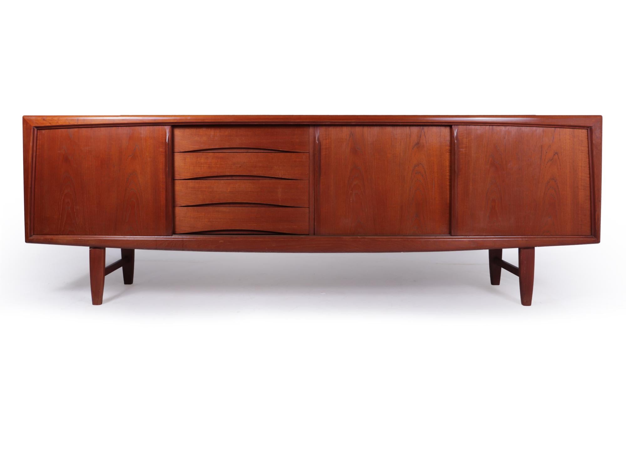 Danish mid century teak sideboard by H P Hansen
A large teak sideboard designed and produced by H P Hansen in Denmark in the 1960’s it has three sliding doors and four drawers with influences from there time working with Arne Vodder, the sideboard