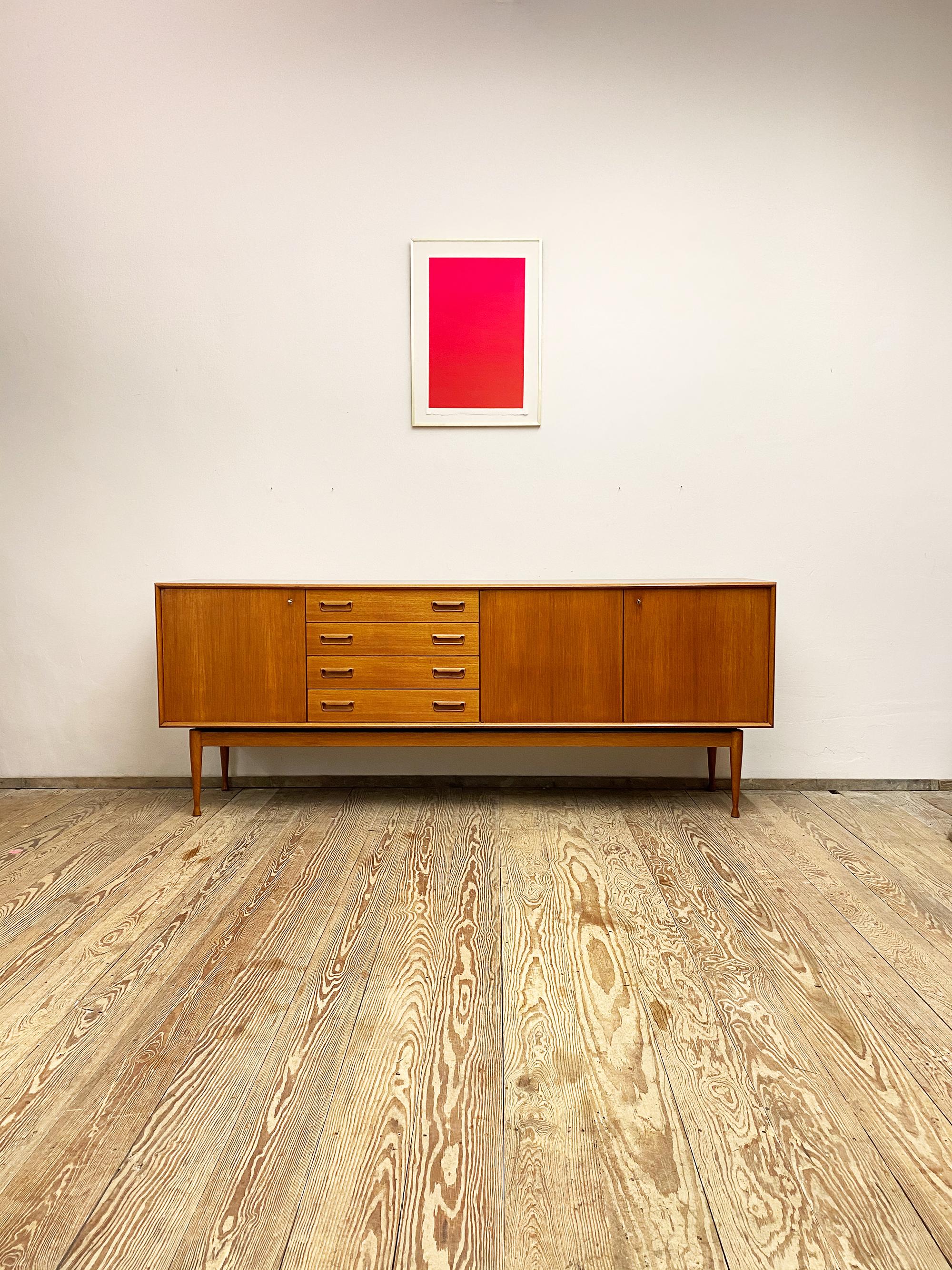 Dimensions 220 x 45 x 85 cm (Width x Depth x Height)

This Scandinavian Mid-Century Modern teak credenza was designed and manufactured in the 1950s in Denmark.

It shows exquisite Danish craftsmanship and offers plenty of storage space on four