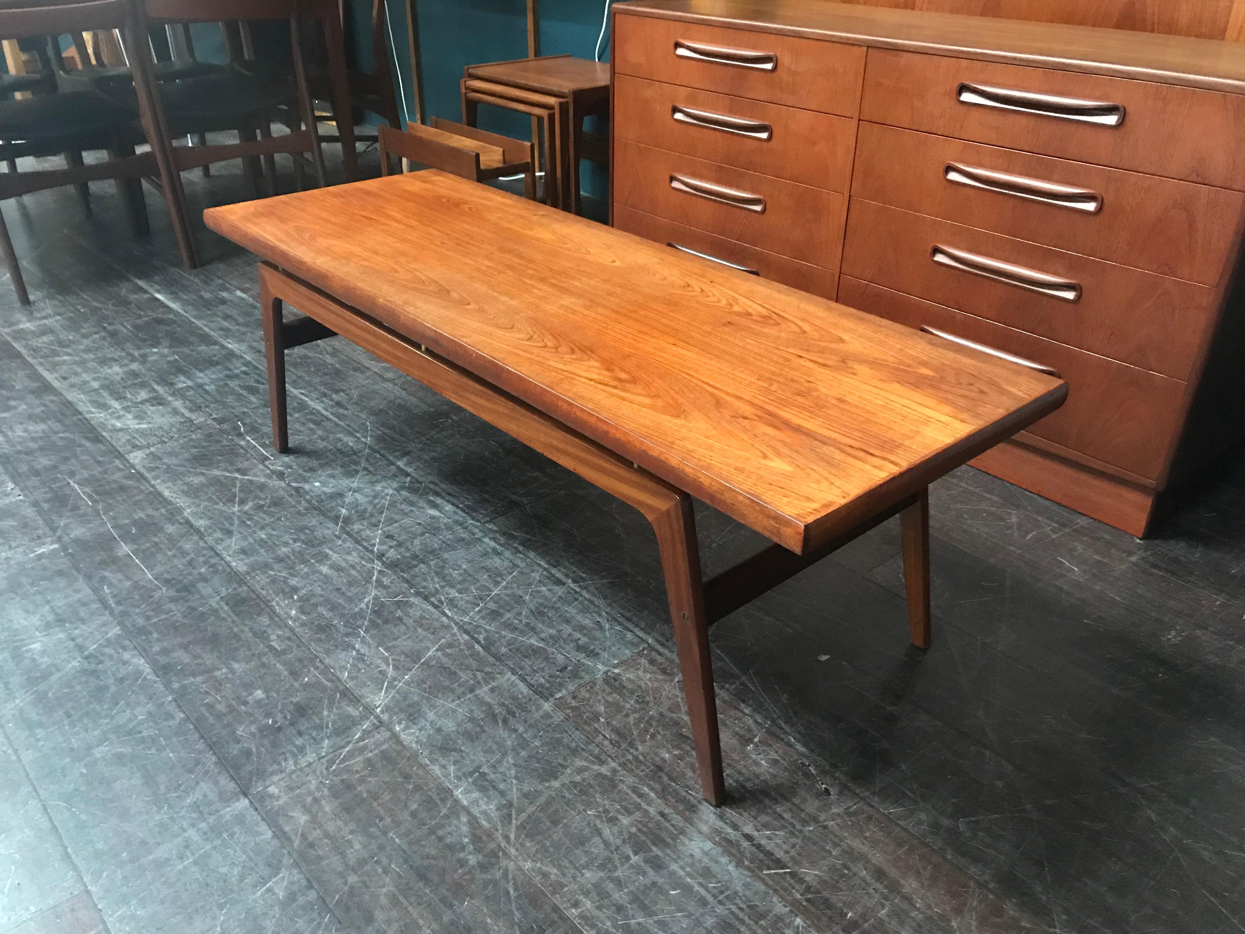 This is a super cool teak Danish coffee table that has fantastic Scandinavian style legs. Long and low, it has a very cool look and lots of space for magazines, laptop and coffee. An extremely stylish and very well constructed piece of midcentury