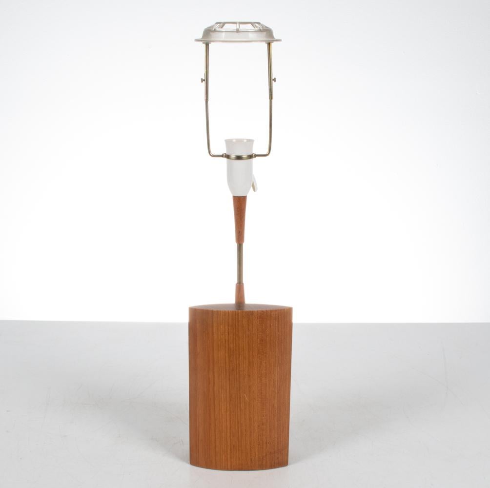 Tauchen Sie ein in den strahlenden Charme der 1960er Jahre mit dieser authentischen dänischen Mid-Century Tischlampe aus Teakholz. Als sublime Verkörperung des skandinavischen Designs verbindet diese Lampe Funktionalität mit Kunstfertigkeit und