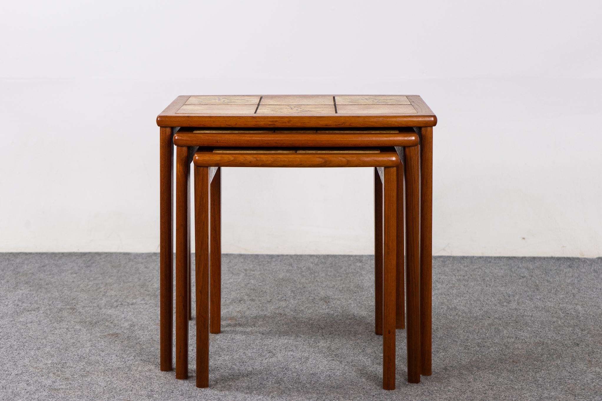 Teak and tile Danish nesting tables, circa 1970's. Space saving design offers the footprint of one table, with the functionality of three! Highly functional and charmingly nostalgic wheat motif tiles act as built it coasters. Darling!.

Make the