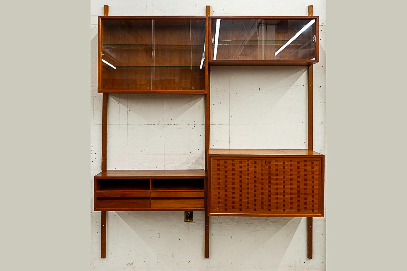 Teak 'Royal' wall system by Poul Cadovius, circa 1960's. This fantastic wall system features solid wood trim with stunning book-matched veneer on surfaces and shows dovetail construction. Modular cabinetry and shelving, a versatile storage solution!