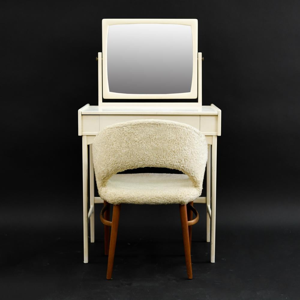Perfect in the bedroom corner of a bohemian apartment or SoHo loft this quaint Danish midcentury vanity by Illums Bolighus includes a lambs wool upholstered chair by Frode Holm.
