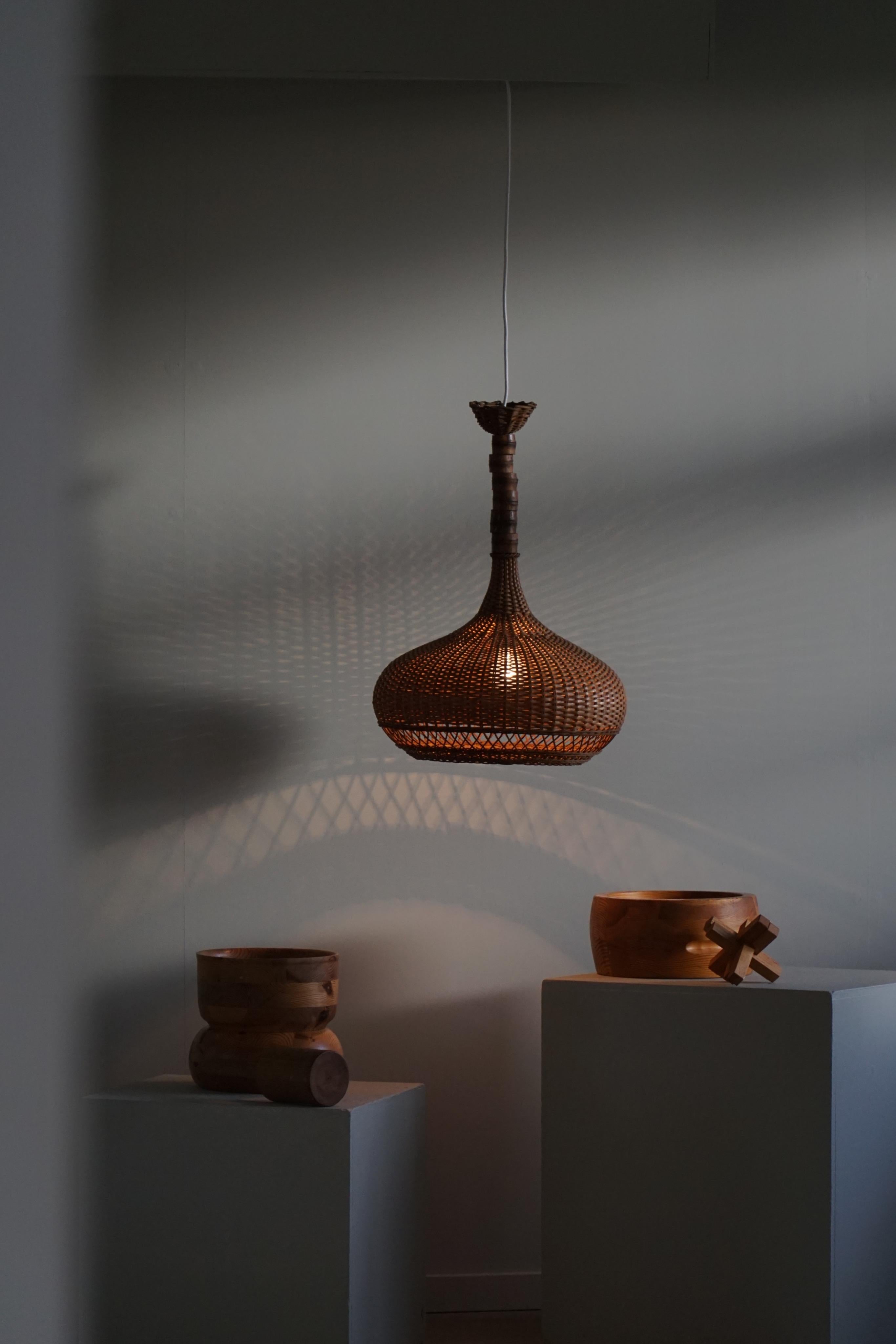 A cosy large pendant light in rattan. Made by a Danish cabinetmaker in 1960s. This pendant gives a calm and cosy light to your home. A beautiful object that pairs well with many types of interior styles. A Modern, Scandinavian, Classic or an Art