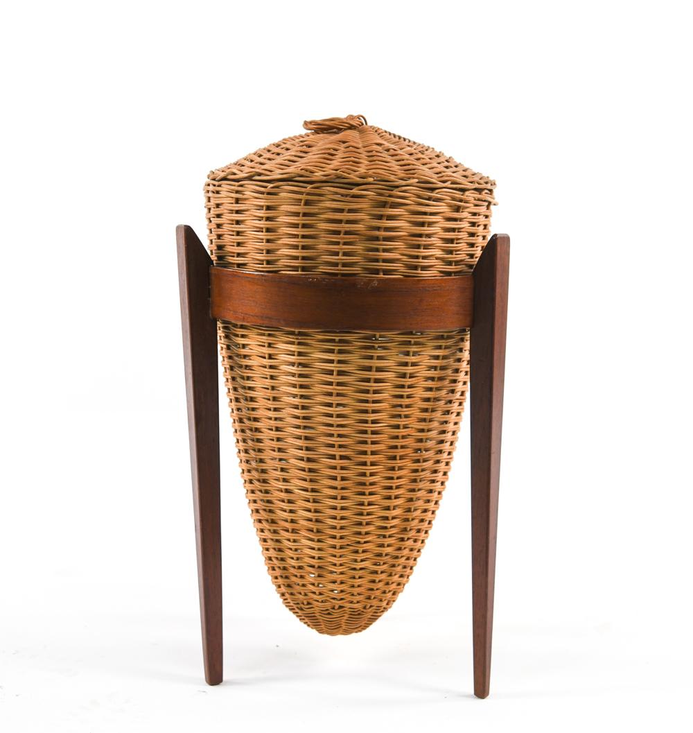 An unusual Danish mid-century tapered wicker basket with ring handle on lid, on shaped teak stand.
