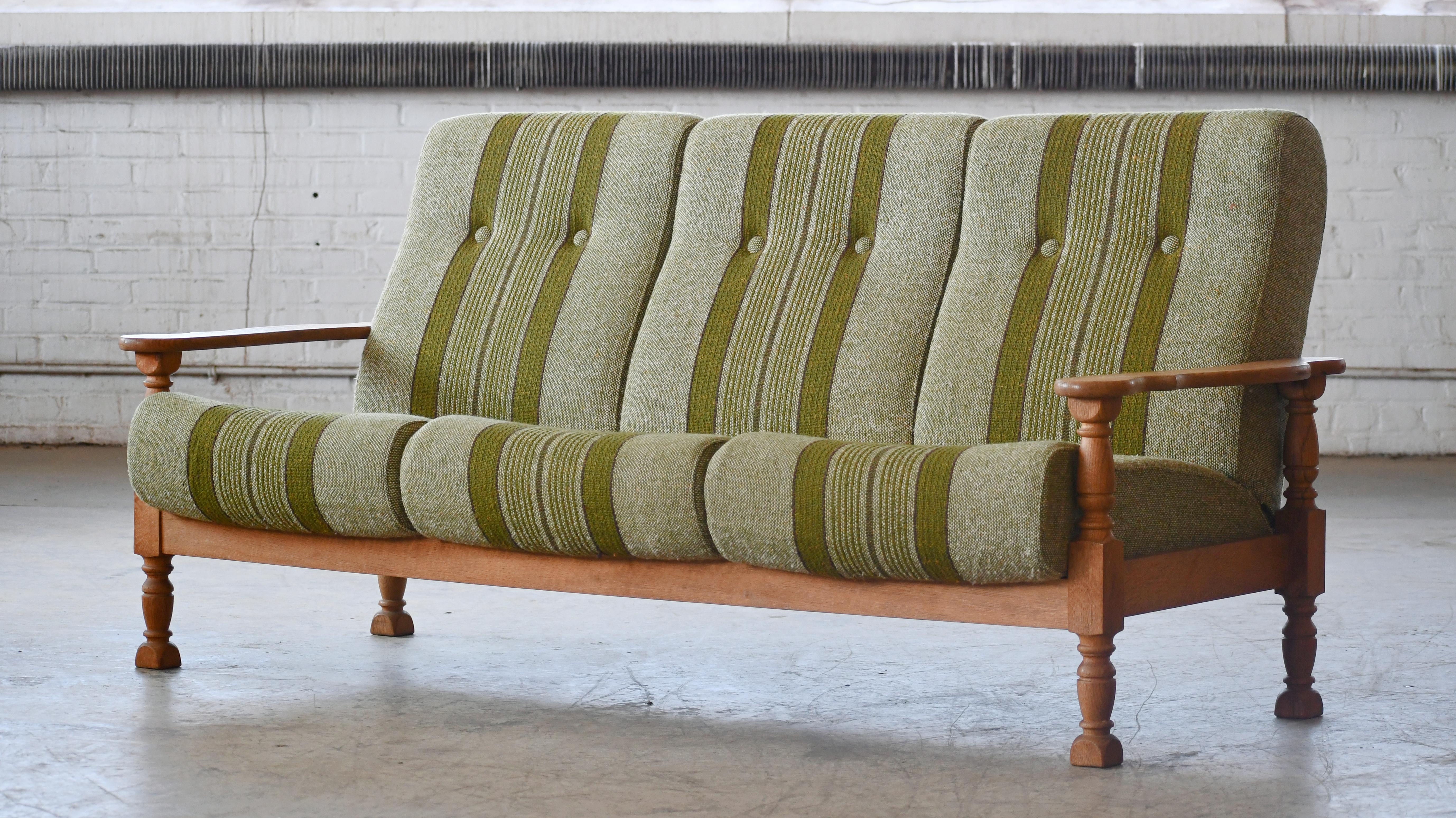 Rare and sought after sofa attributed to Danish Designer, Henning Kjaernulf made from quarter-sawn white oak, Hand carved in brutalist style seeking inspiration from art & crafts and even Jacobean styles. Kjaernulf's style is very unique and