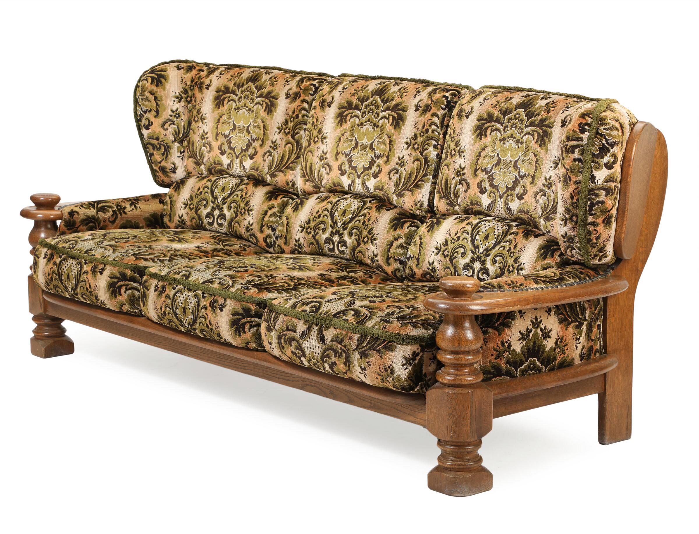 Fantastic fancyful and sought after sofa in the style of Danish Designer, Henning Kjaernulf. made from stained solid white oak, Hand carved in brutalist style seeking inspiration from art & crafts and even Jacobean styles. Kjaernulf's style is very