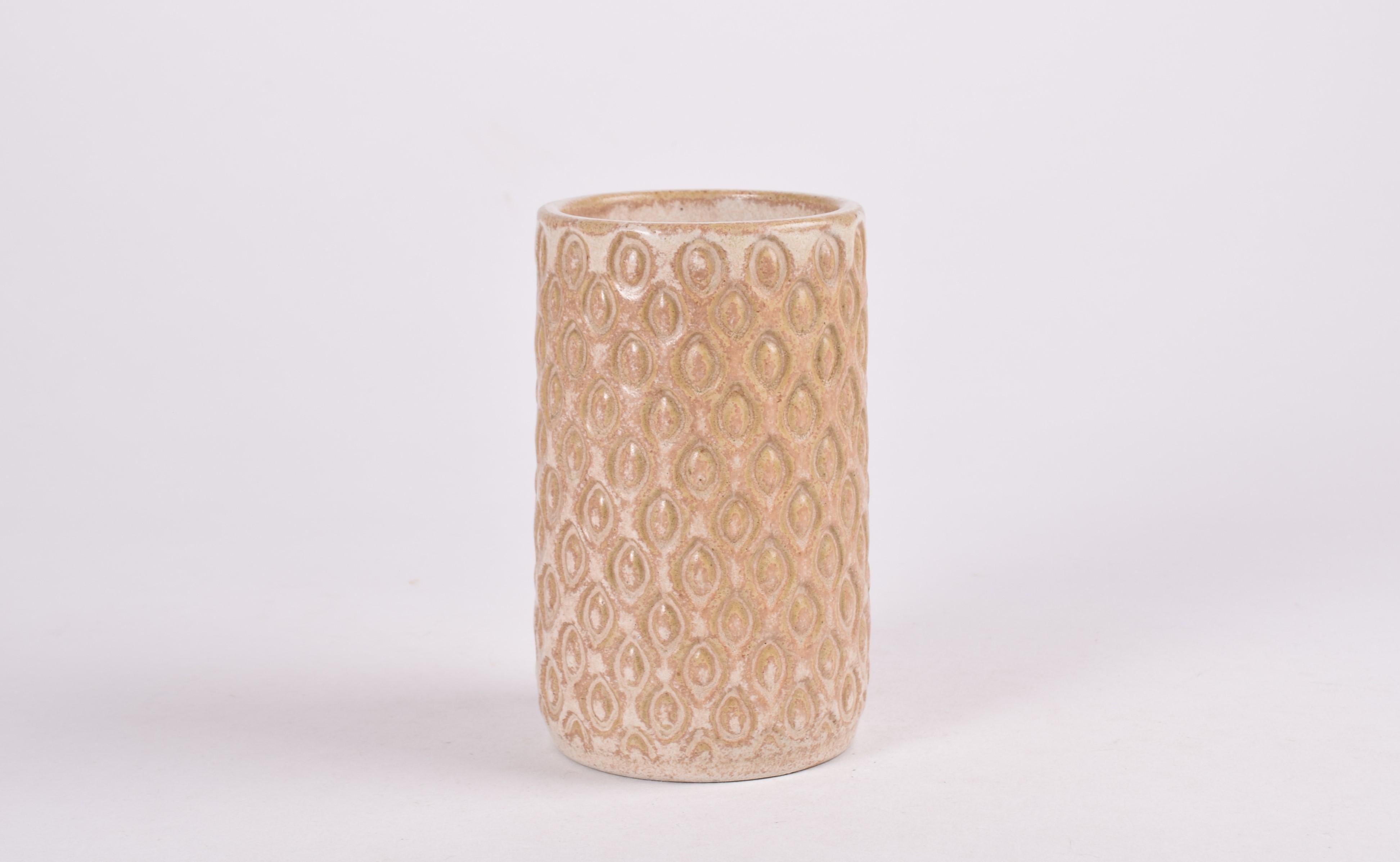Cylindrical ceramic vase in budding style by Eva Sjögren for the Danish ceramic studio L. Hjorth. Made ca 1940s-60s.

It has a beautiful speckled glaze in sand color which adds extra vividness to the already structured surface. Very tactile.

Fully