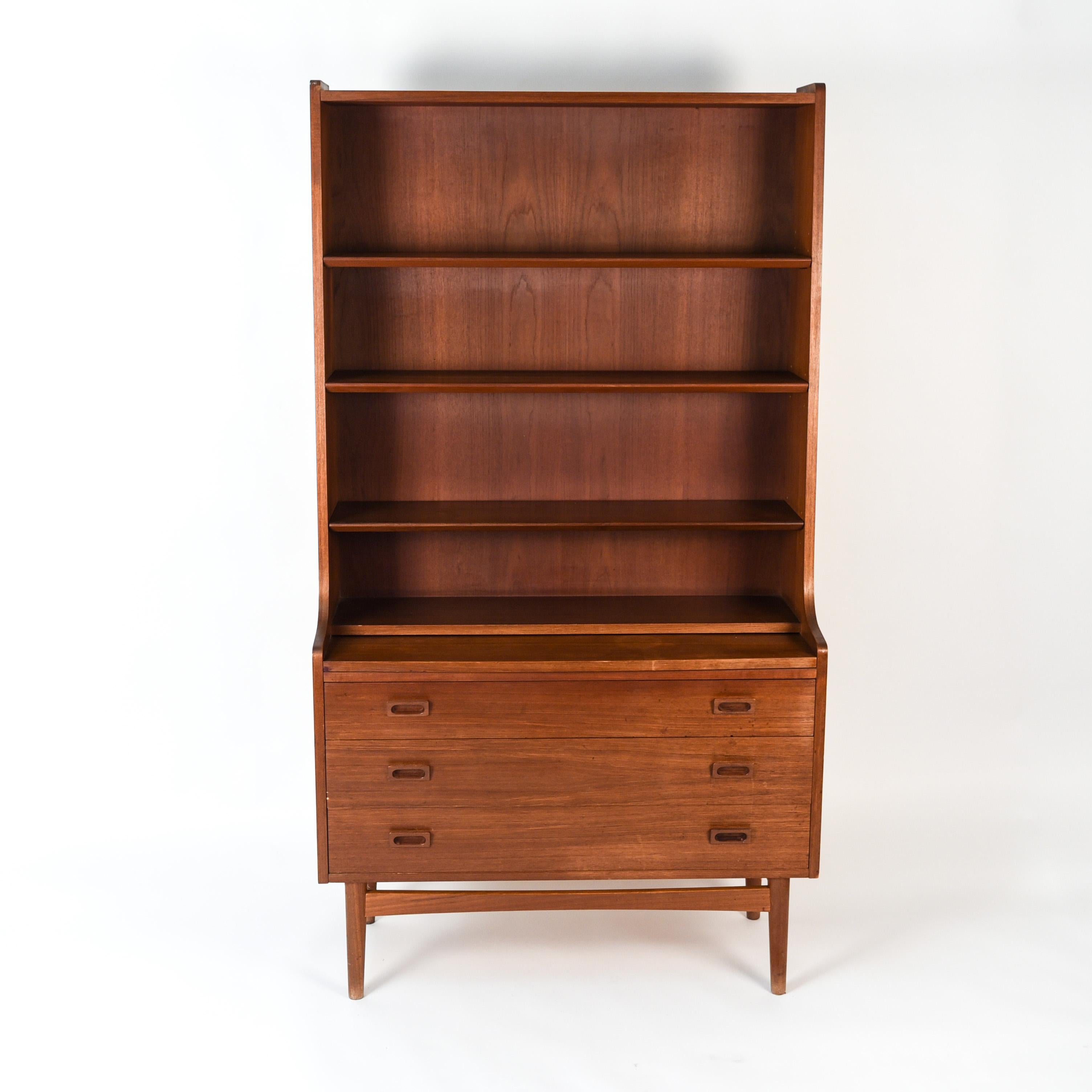 This teak bookcase or secretary was designed by Johannes Sorth for Bornholm Møbelfabrik, Nexø. This bookcase features adjustable shelves which sit above three drawers. This doubles as a great storage and display piece, while maintaining the
