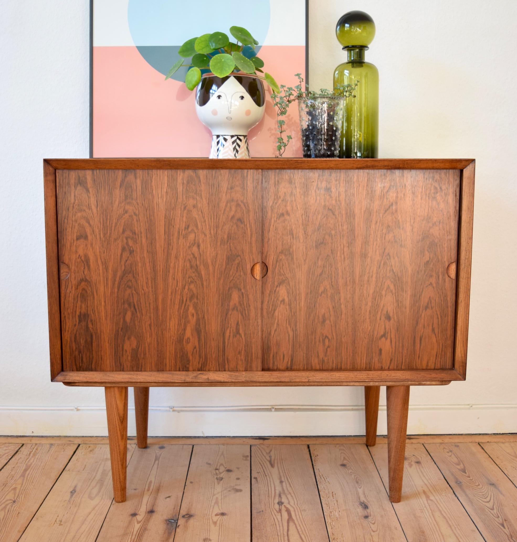 Rosewood Bar/Record cabinet by Cado, designed by Poul Cadovius in 1960. This is a 'stand alone' version of the unit which form part of the modular wall systems. Features two sliding doors and one adjustable internal shelf, which can be removed so