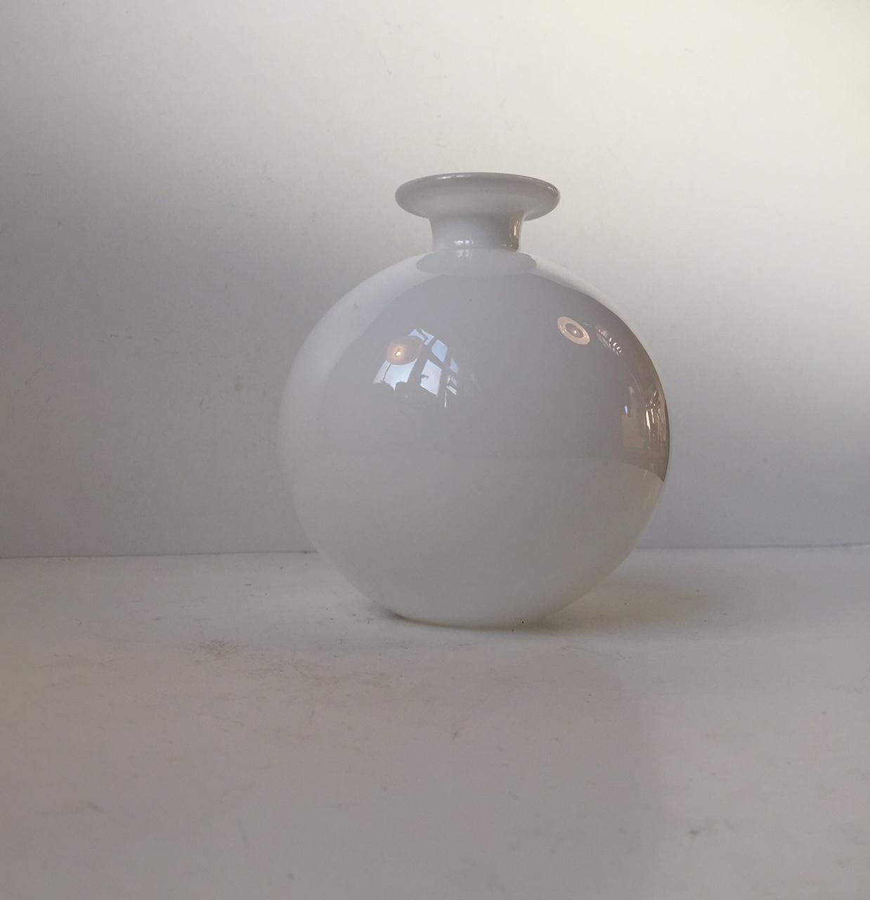 This cased white opaline glass vase was designed by Per Lütken in 1968 and manufactured by Holmegaard in Denmark until 1976. This shape in this color, from the Carnaby/Palet series, is the rarest.