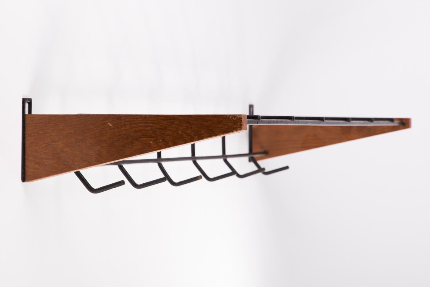 Steel painted with teak brackets, made in Denmark in the 1960s.
 
