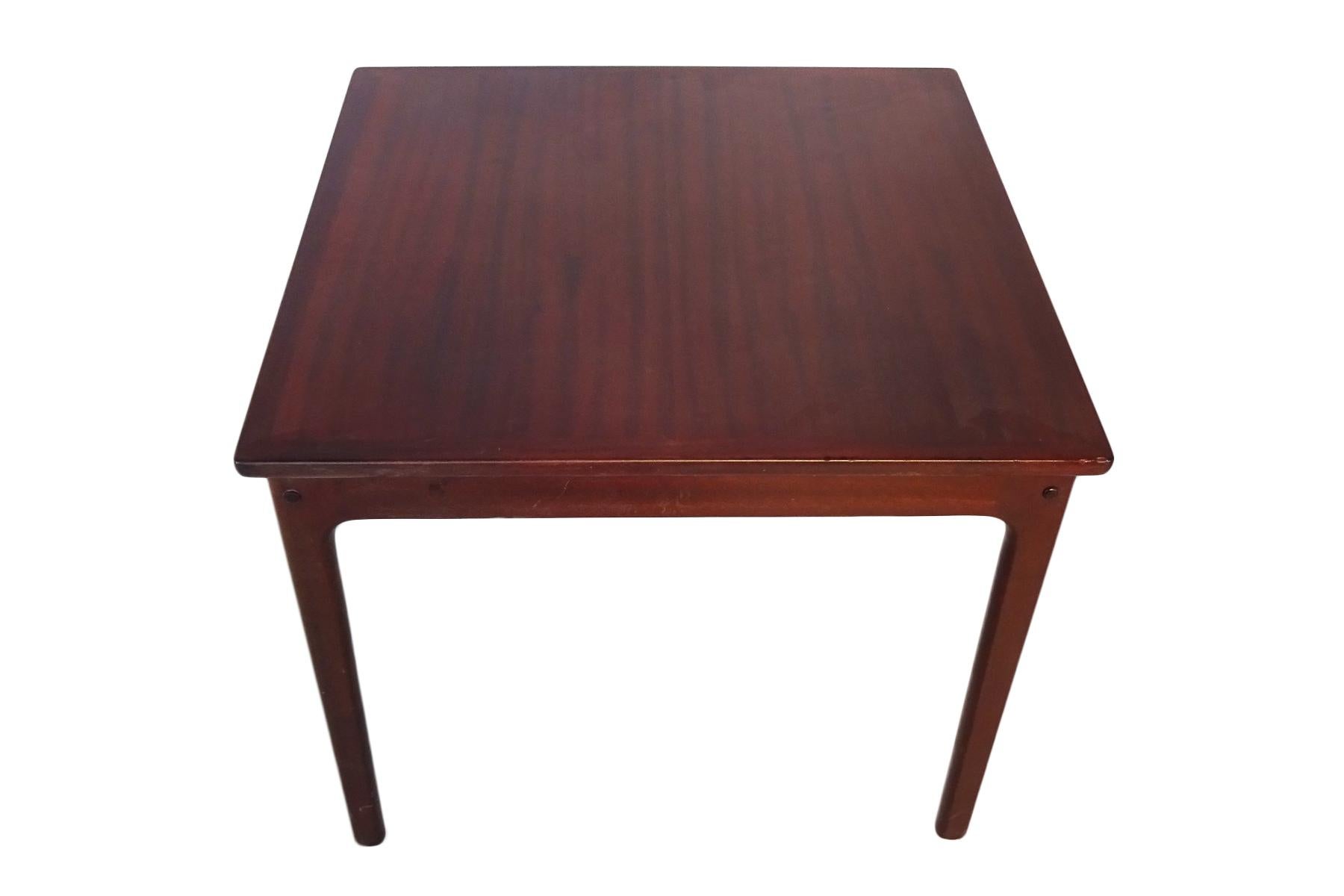 Danish midcentury mahogany coffee or side table by Ole Wanscher for Poul Jeppesen Møbelfabrik.

Born in Copenhagen in 1903, Danish architect and designer Ole Wanscher played a pivotal part in Denmark's Mid-Century Modern movement. His simple but