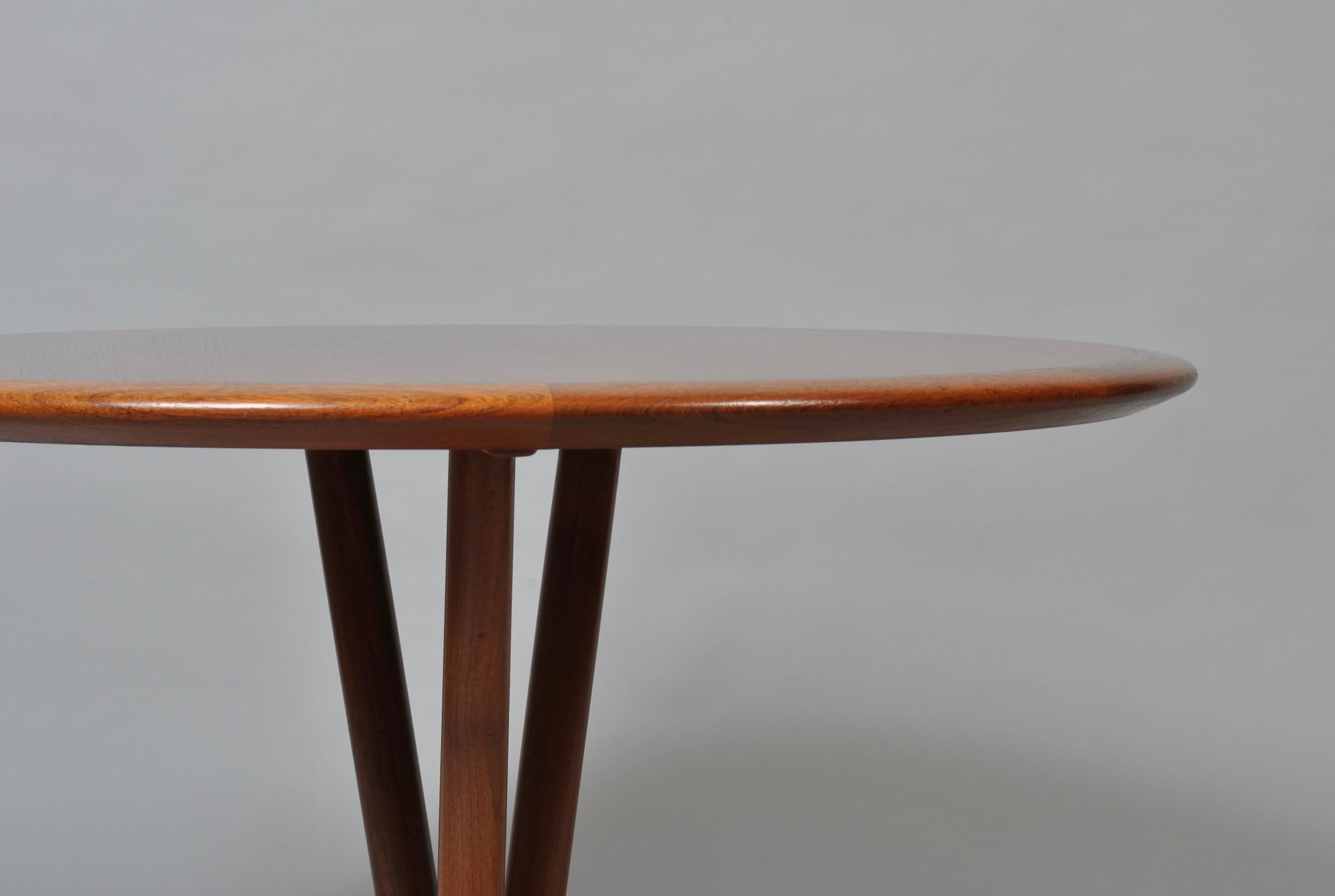 Superior design and construction of this Danish teak coffee table. Produced, circa 1960s. Highly unusual tri-leg design base. Beautifully crafted and with a superb aged colouring. Easily dismantled for safe shipping (if required). Terrific