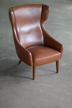 Danish Midcentury Cognac Colored Highback Lounge Chair with Ottoman by Spottrup