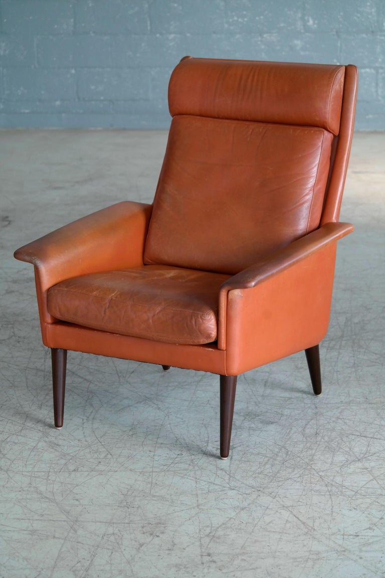 Danish Midcentury Cognac Colored High Back Lounge Chair with Ottoman by