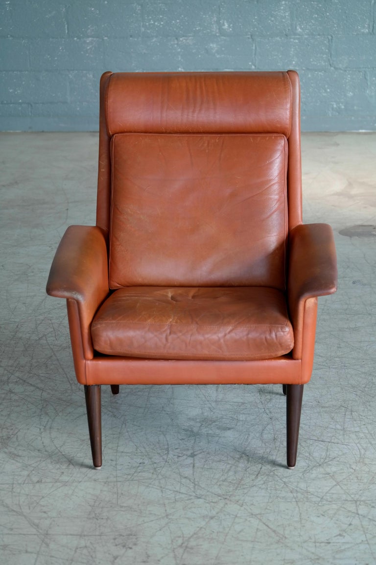 Danish Midcentury Cognac Colored High Back Lounge Chair with Ottoman by