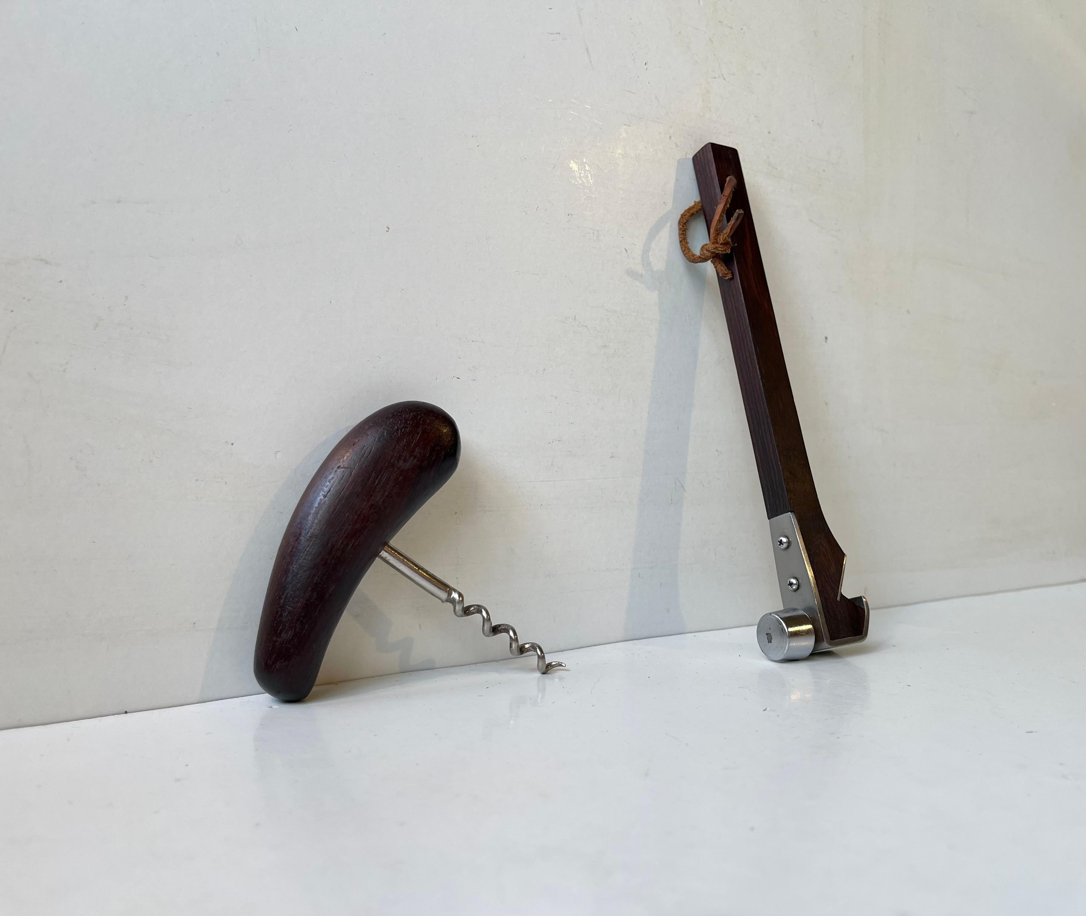 Ingenious leather-strapped bottle opener with integrated nut or ice hammer. Its executed in stainless steel and rosewood. It accompanied by a rosewood corkscrew with organically hand-crafted ergonomical handle. This piece was made during the 1950s