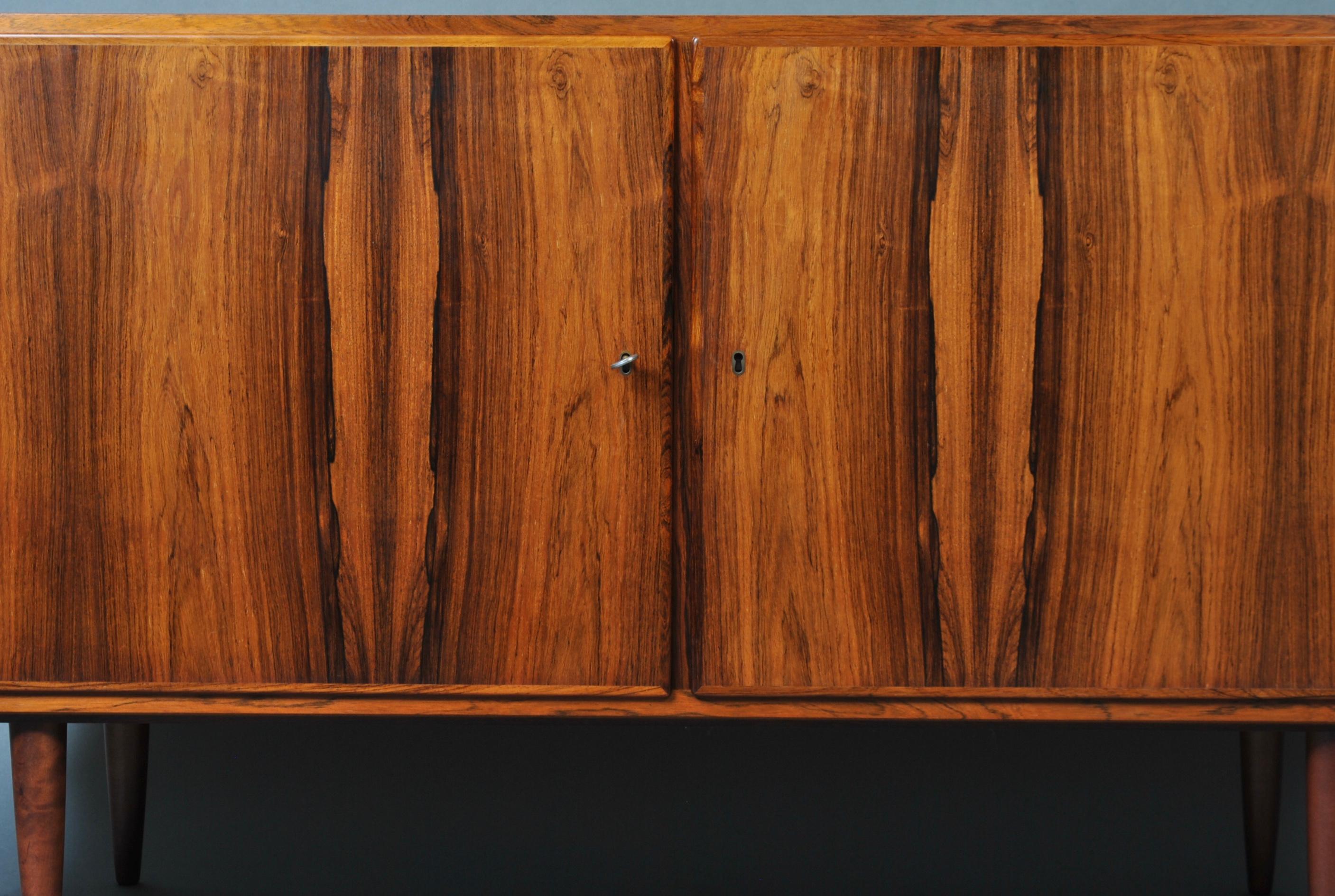 A superb example of a mid-size Danish midcentury Credenza - sideboard by Poul Hundevad. Incredible colouring, figuring and grain. Lockable doors. Maple veneer interior with adjustable shelf one side and 2 adjustable drawers to the other.